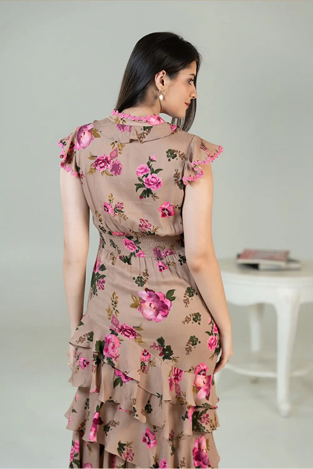 Back view of beige floral midi dress with tiered ruffles and rose print