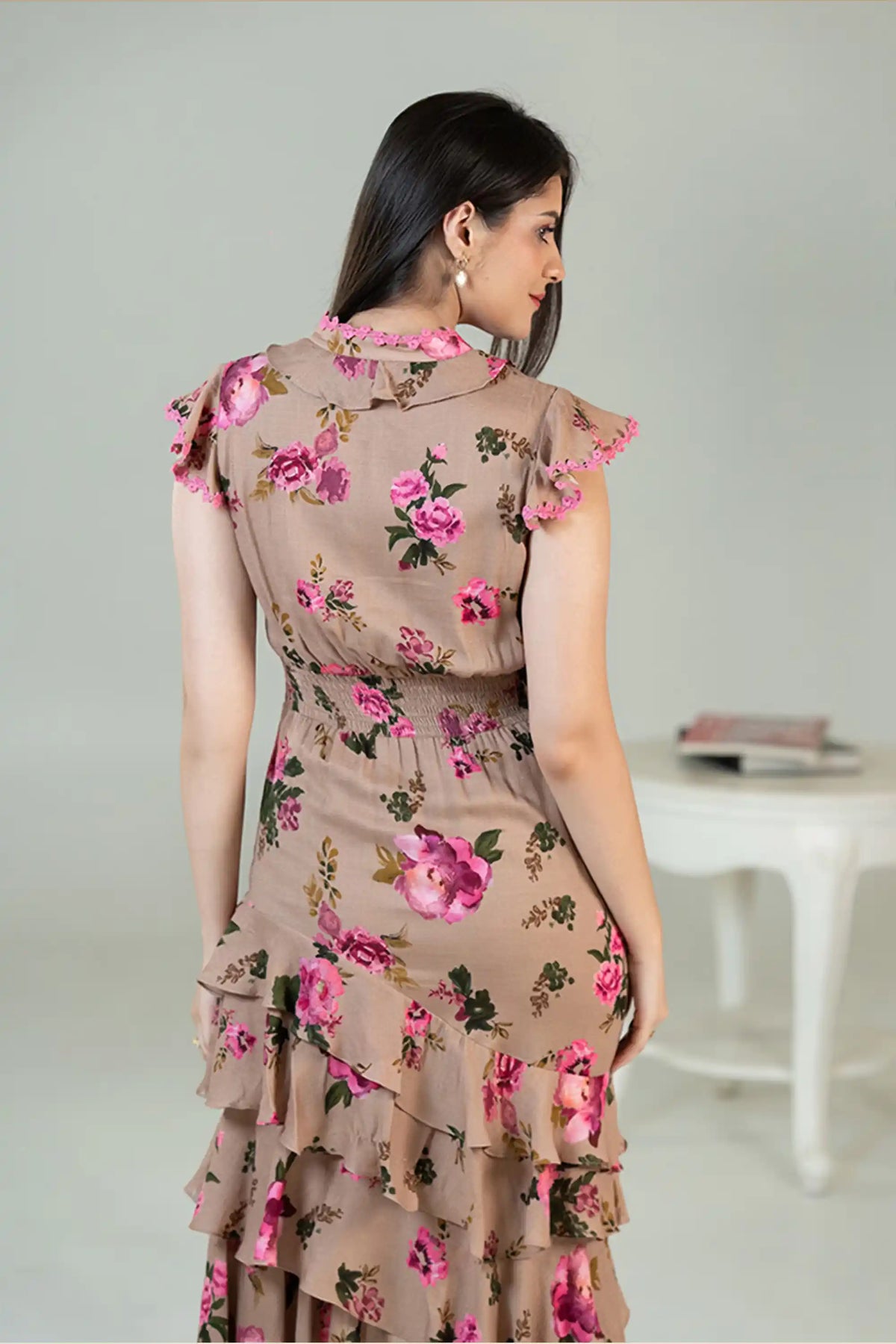 Back view of beige floral midi dress with tiered ruffles and rose print