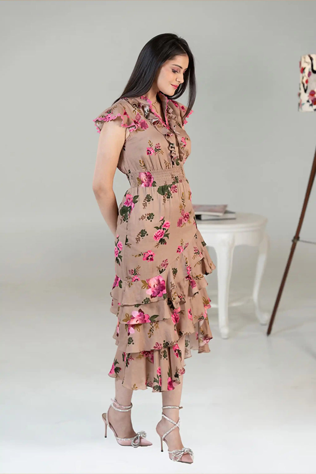 Side profile of sleeveless floral ruffle midi dress with layered skirt