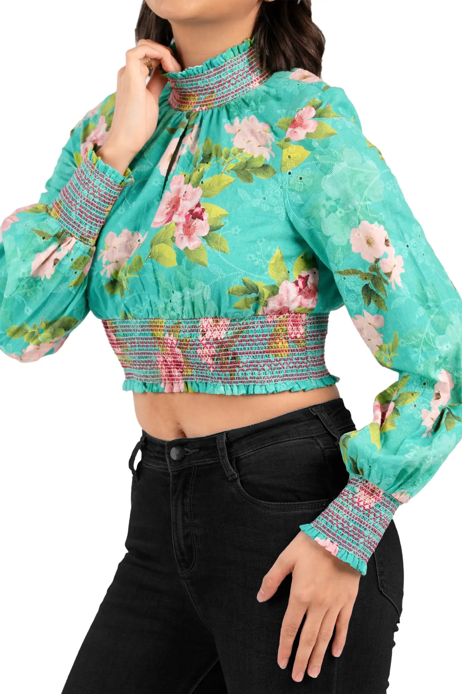 Detail of smocked cuffs and waistband on green floral crop top, modern casual design for women