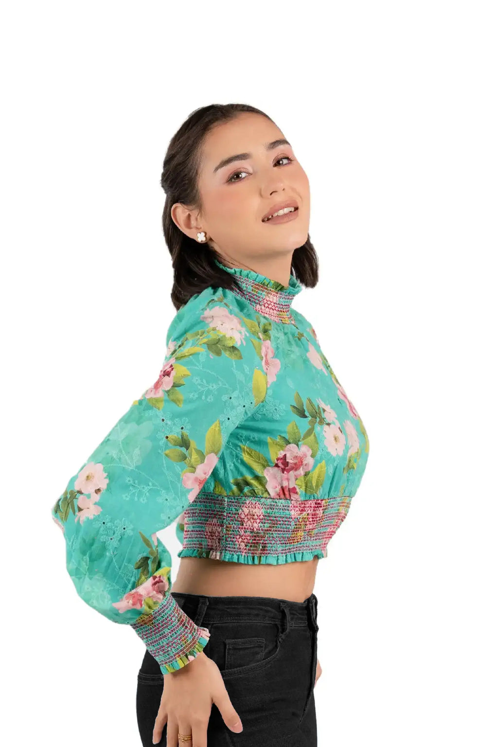 woman wearing green floral smocked crop top, statement sleeves and vibrant floral print
