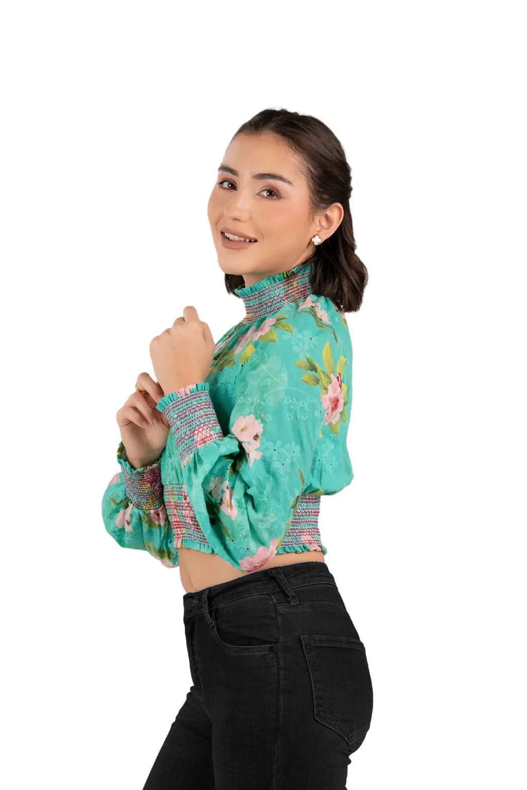 Side profile of green floral smocked crop top on woman, gathered neck and cuffs, trendy spring style