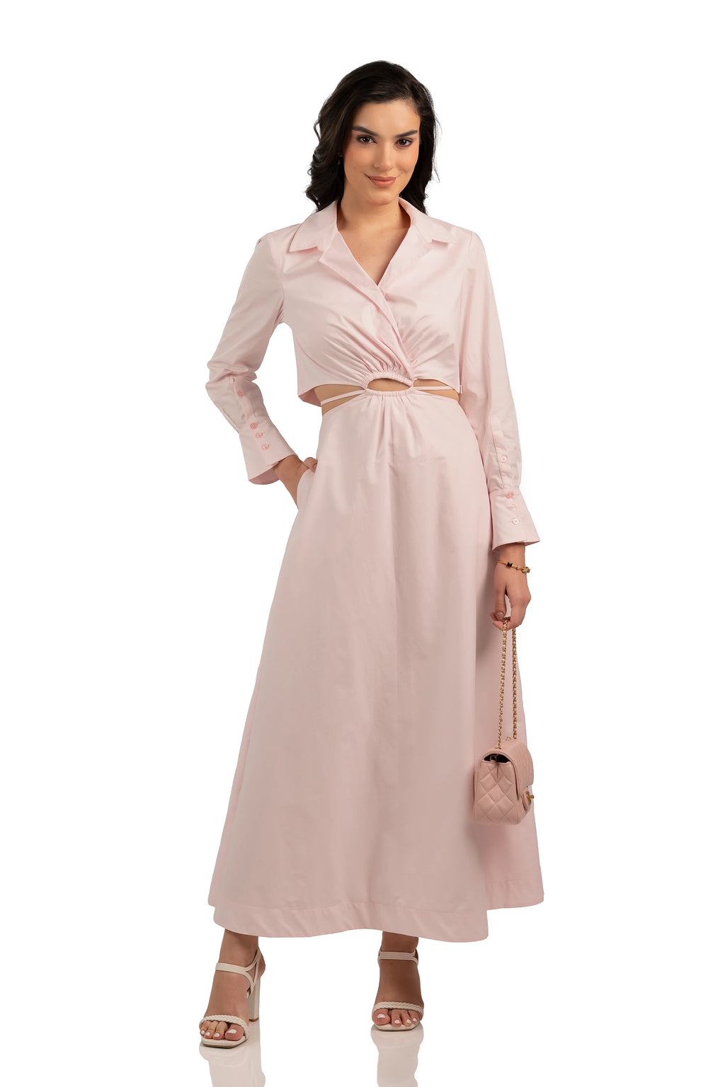 Model wearing front view of blush pink maxi dress with collared neckline, gathered waist cutout, and long sleeves.