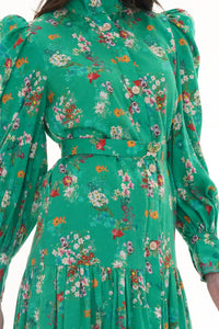 Woman in Pretty Pixie green floral high-neck belted shirt dress with butterfly brooch, back detail