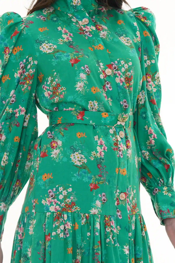 Woman in Pretty Pixie green floral high-neck belted shirt dress with butterfly brooch, back detail