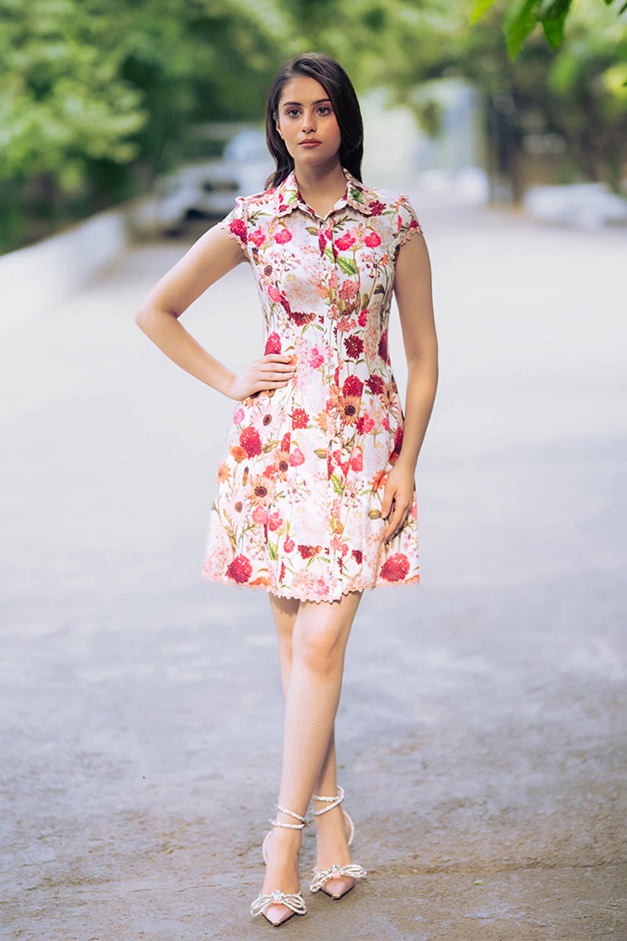 Front view of ivory floral collared shirt dress with sleeveless design and lace hem