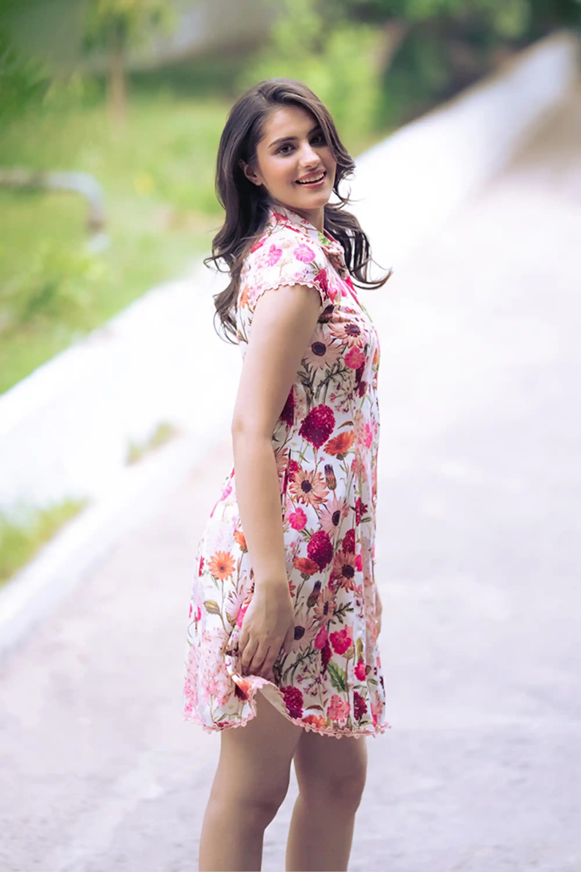 Playful pose in ivory floral collared shirt dress with bright floral prints