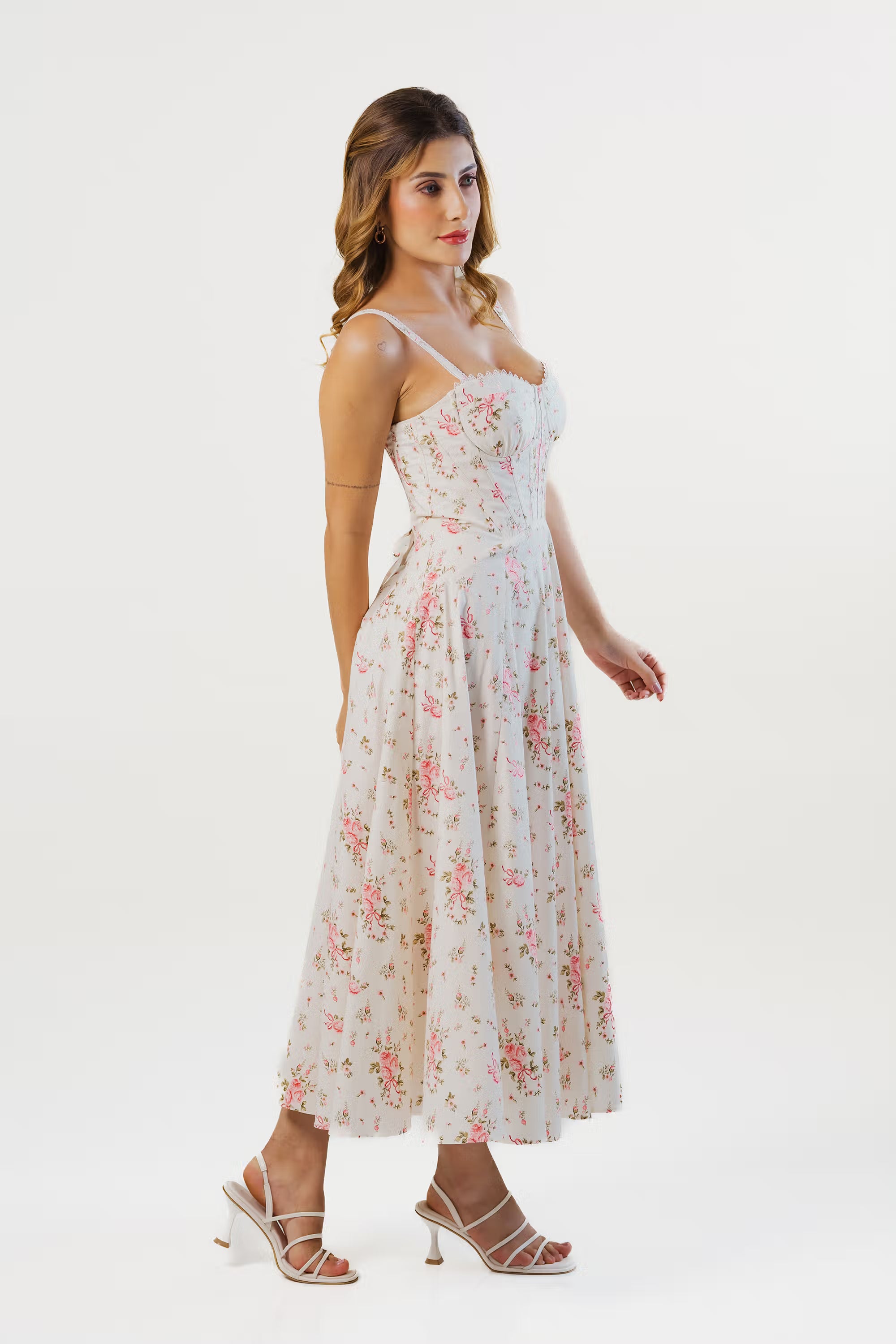 Ivory floral corset midi dress side view highlighting waist fit and flared skirt