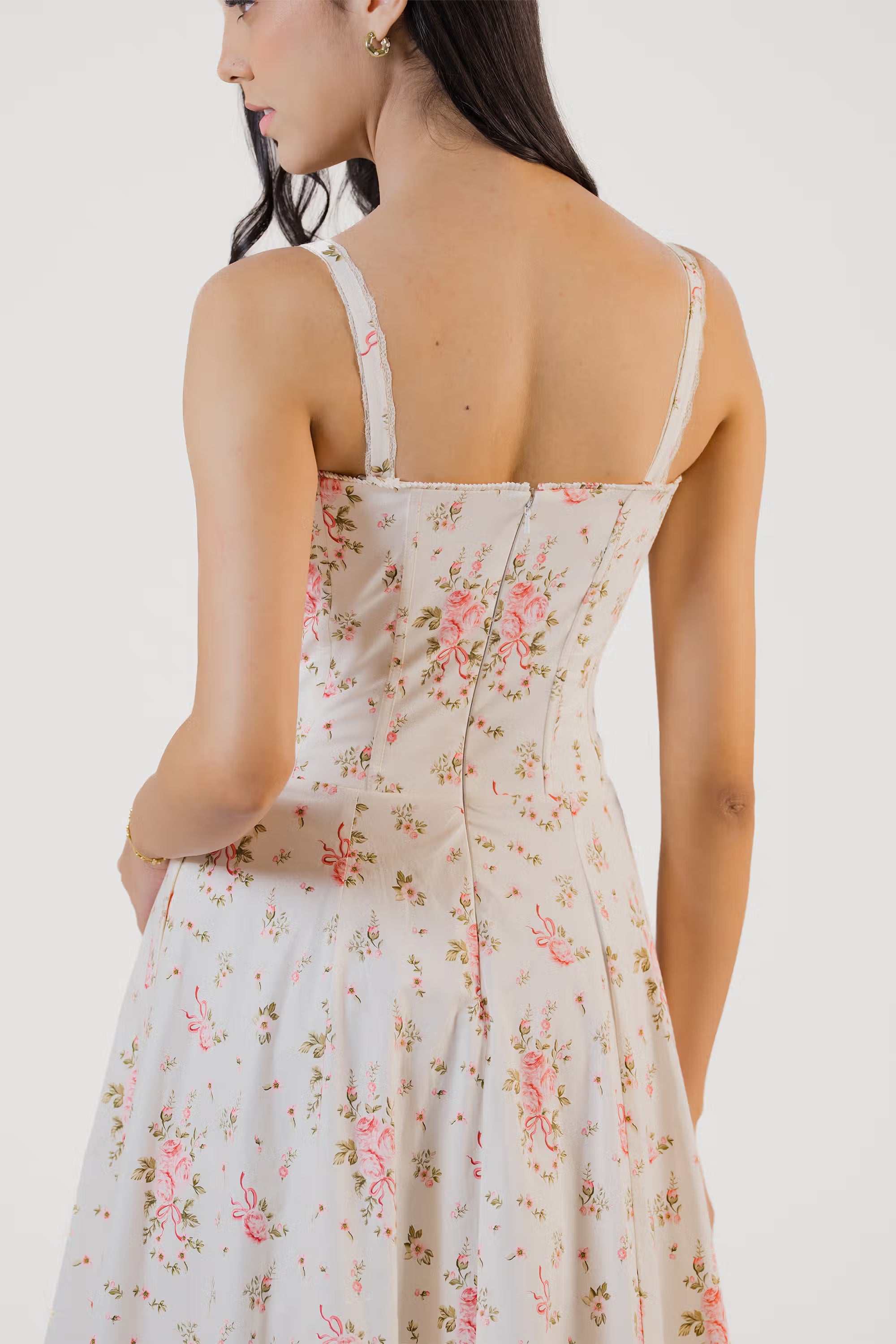 Close-up of back bodice design with stitched seams and rose floral pattern.