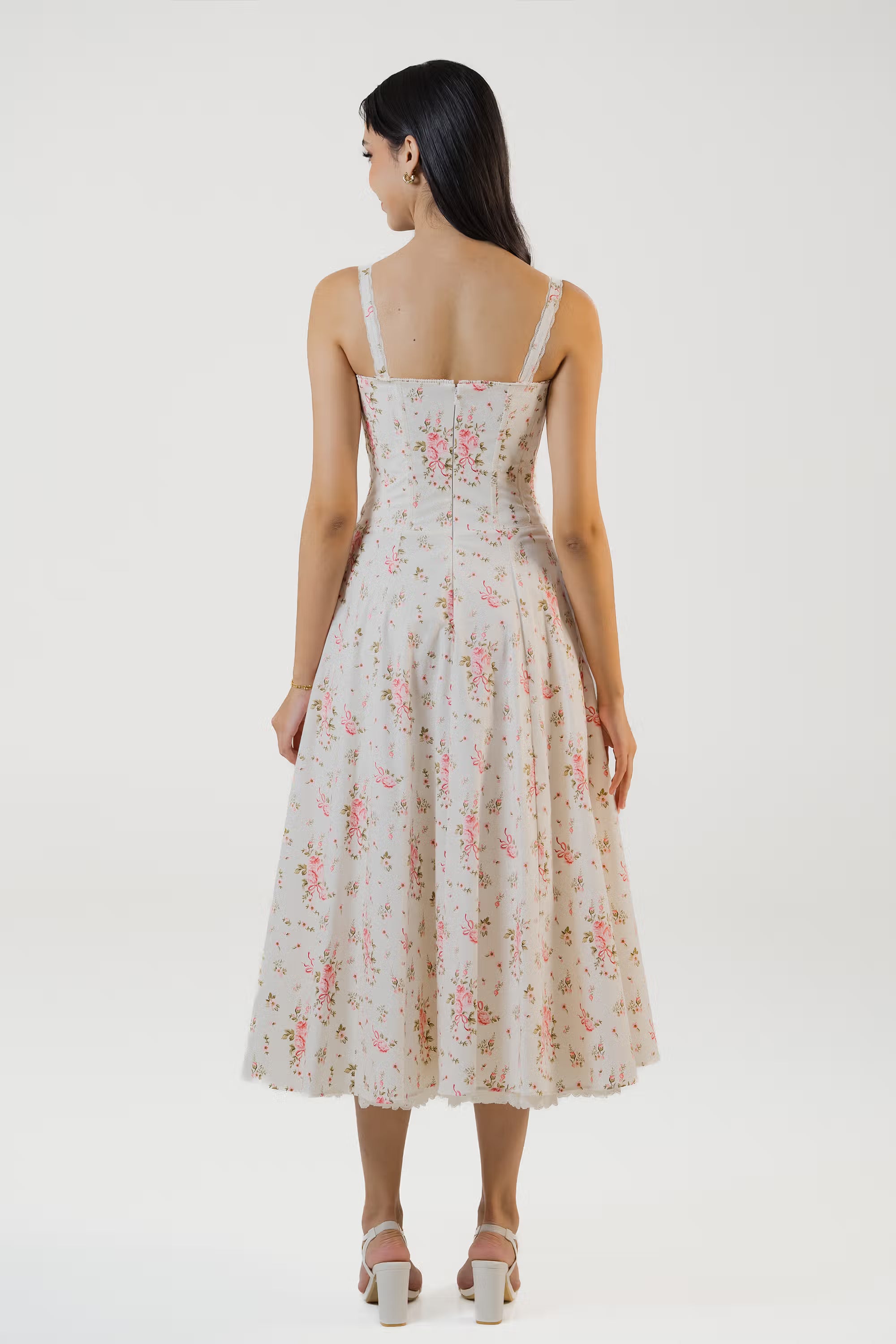 Back view of ivory floral dress with zip closure and full skirt.