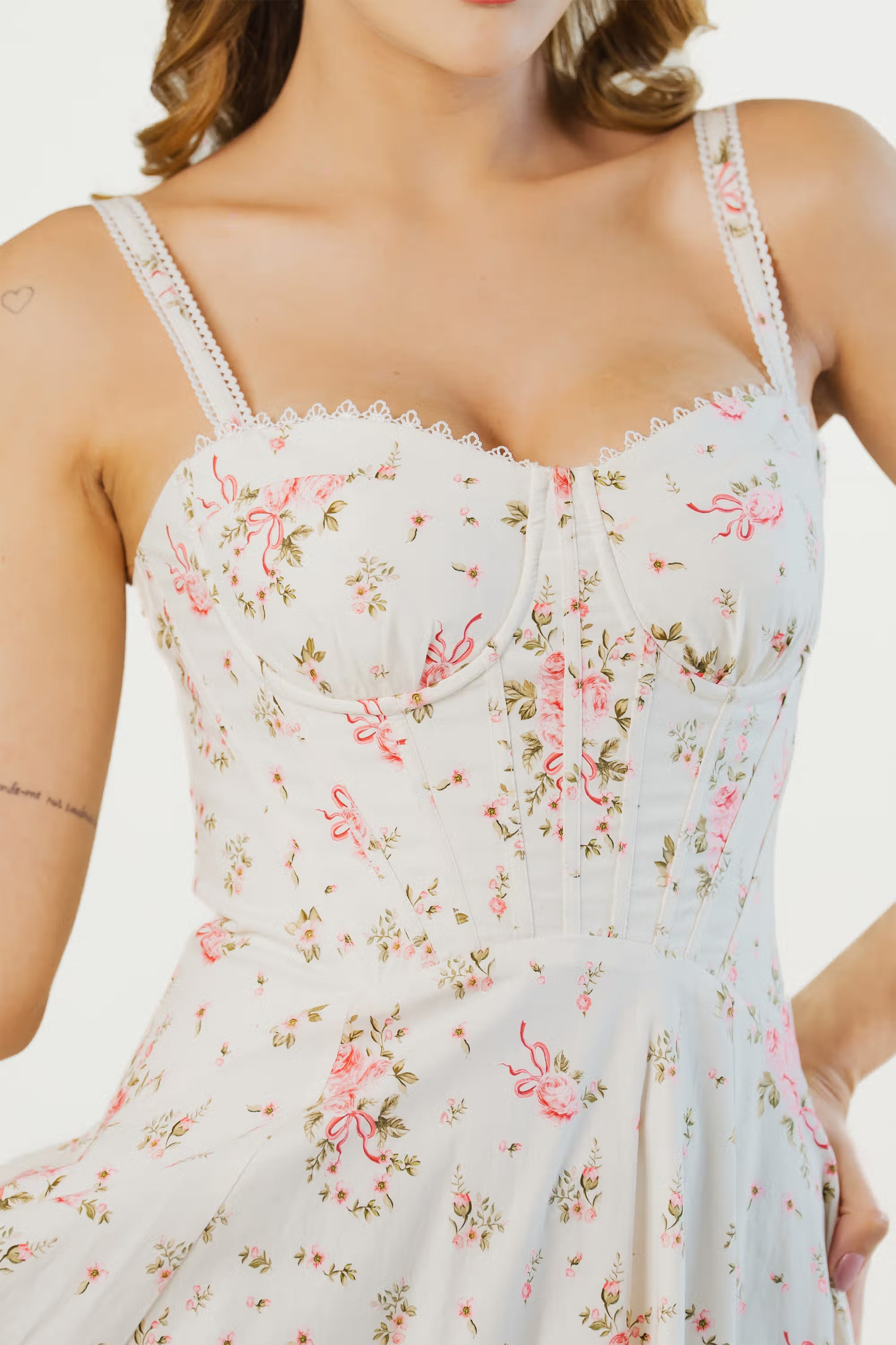 Close-up of ivory floral midi dress bodice with corset detailing and lace straps