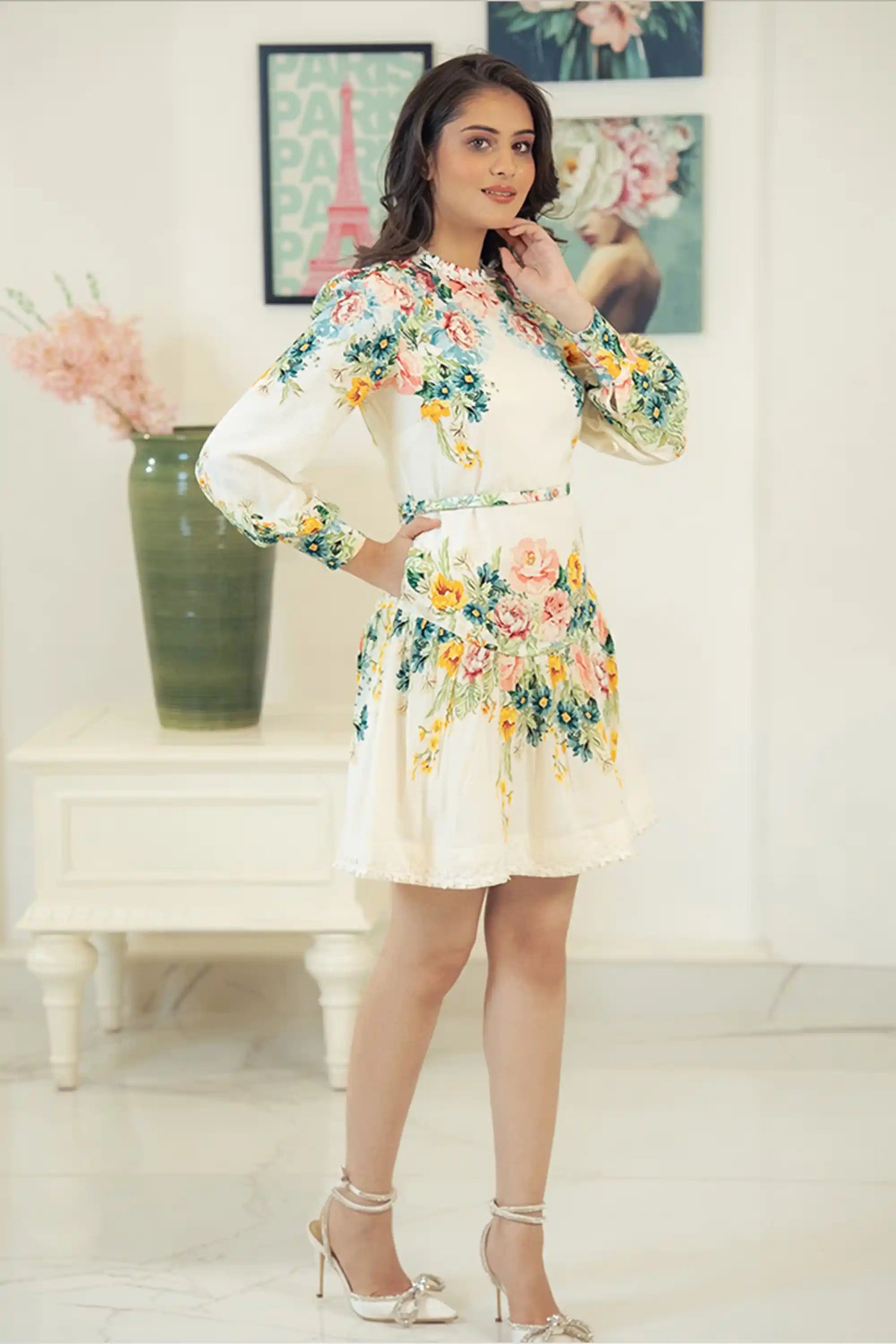 Smiling model in ivory floral mini dress with colorful flower prints