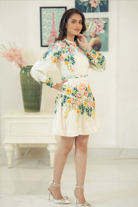 Smiling model in ivory floral mini dress with colorful flower prints