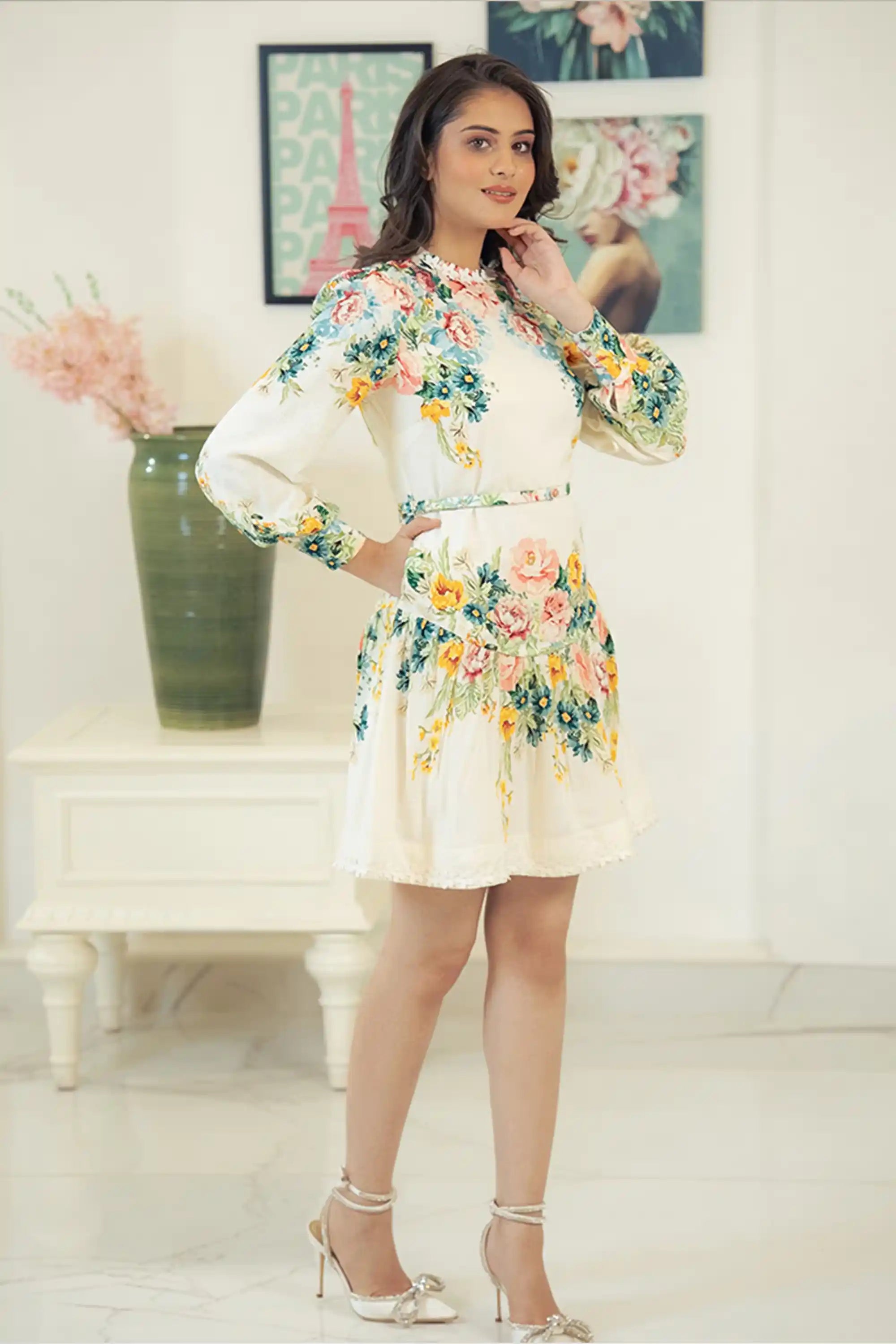Smiling model in ivory floral mini dress with colorful flower prints