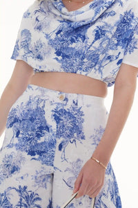 Close-up of Pretty Pixie ivory floral puff-sleeve belted mini dress