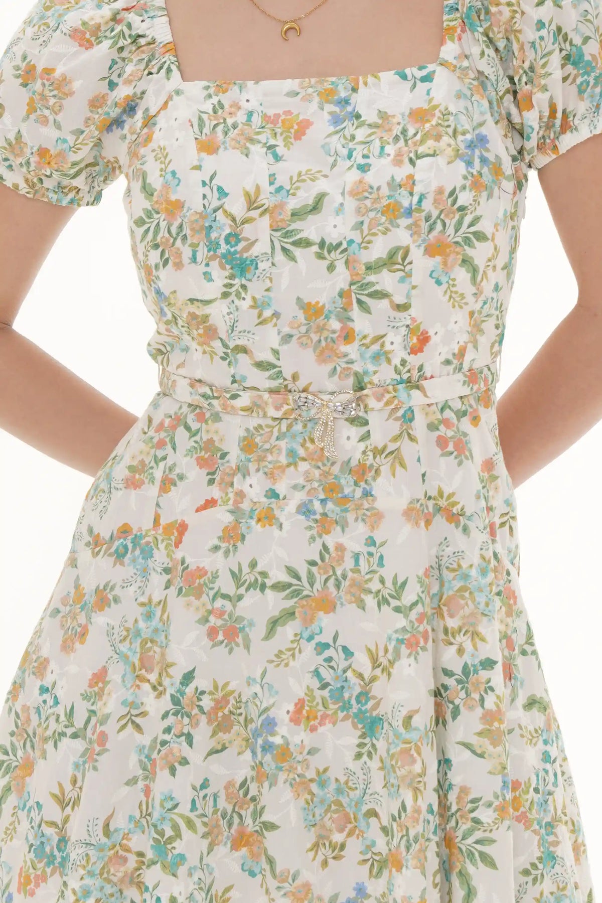 Close-up of Pretty Pixie ivory floral puff-sleeve belted mini dress, waist detail