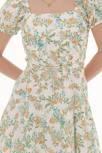 Close-up of Pretty Pixie ivory floral puff-sleeve belted mini dress, waist detail