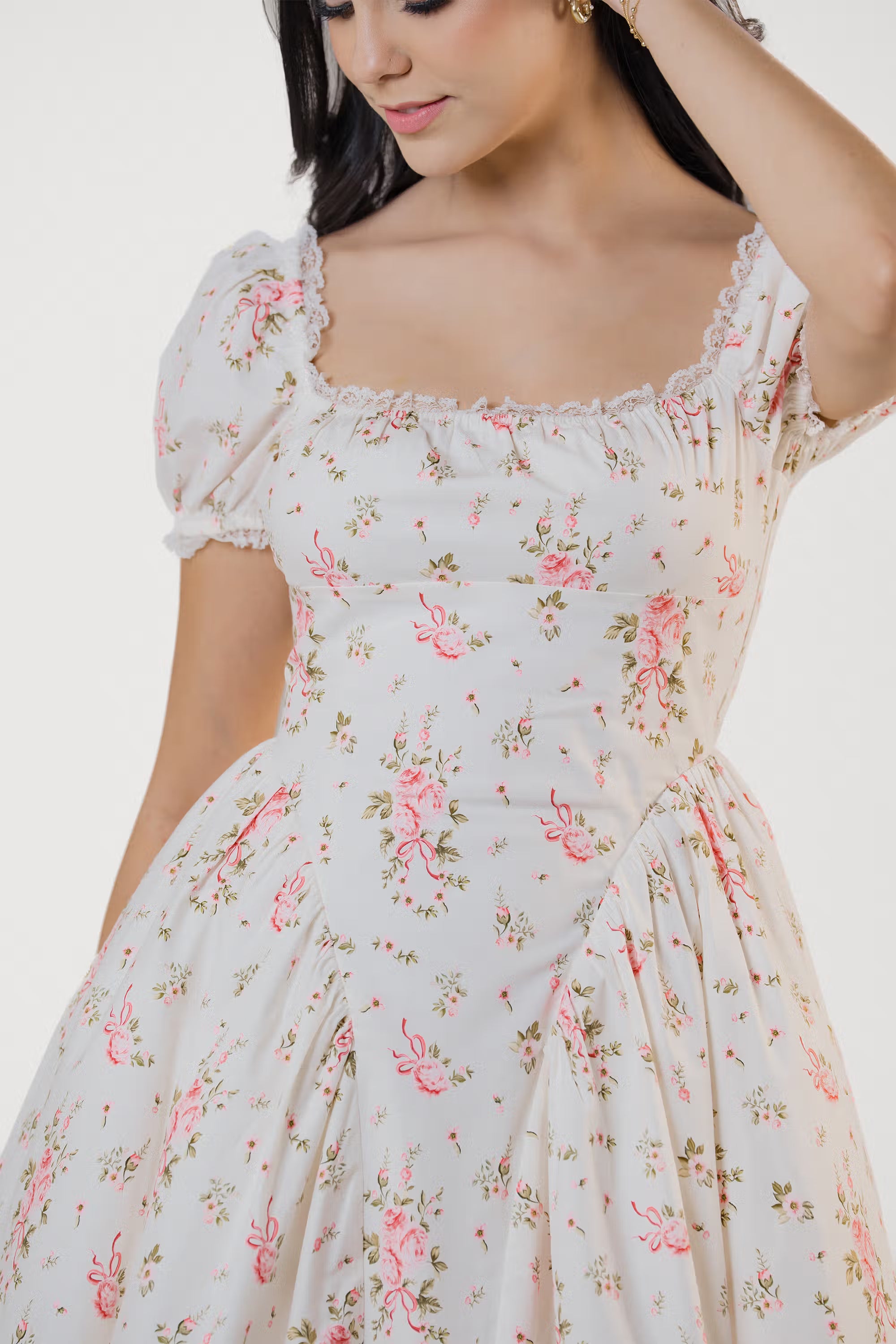 Close-up of ivory floral puff sleeve mini dress bodice with pink rose print