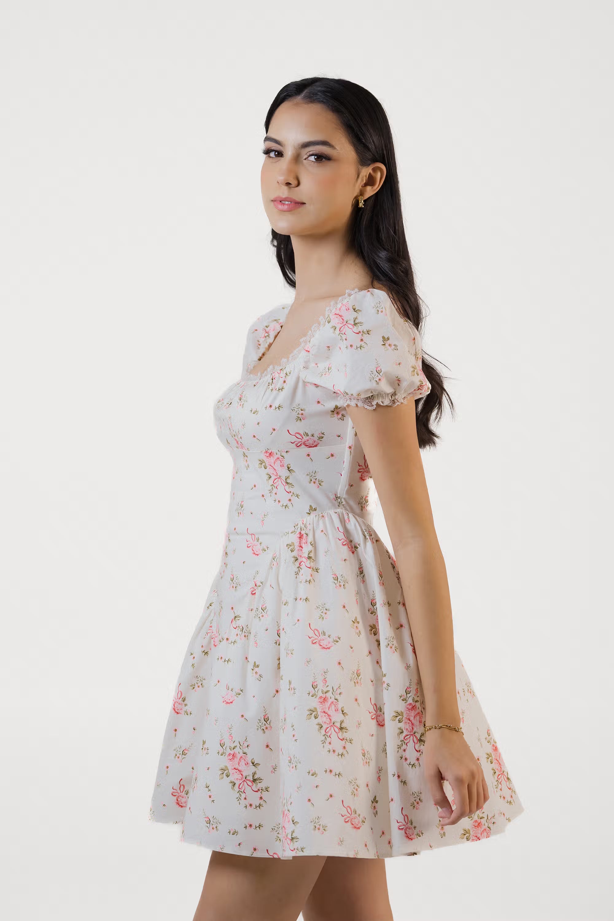 Side profile of ivory floral puff sleeve mini dress with soft A-line silhouette