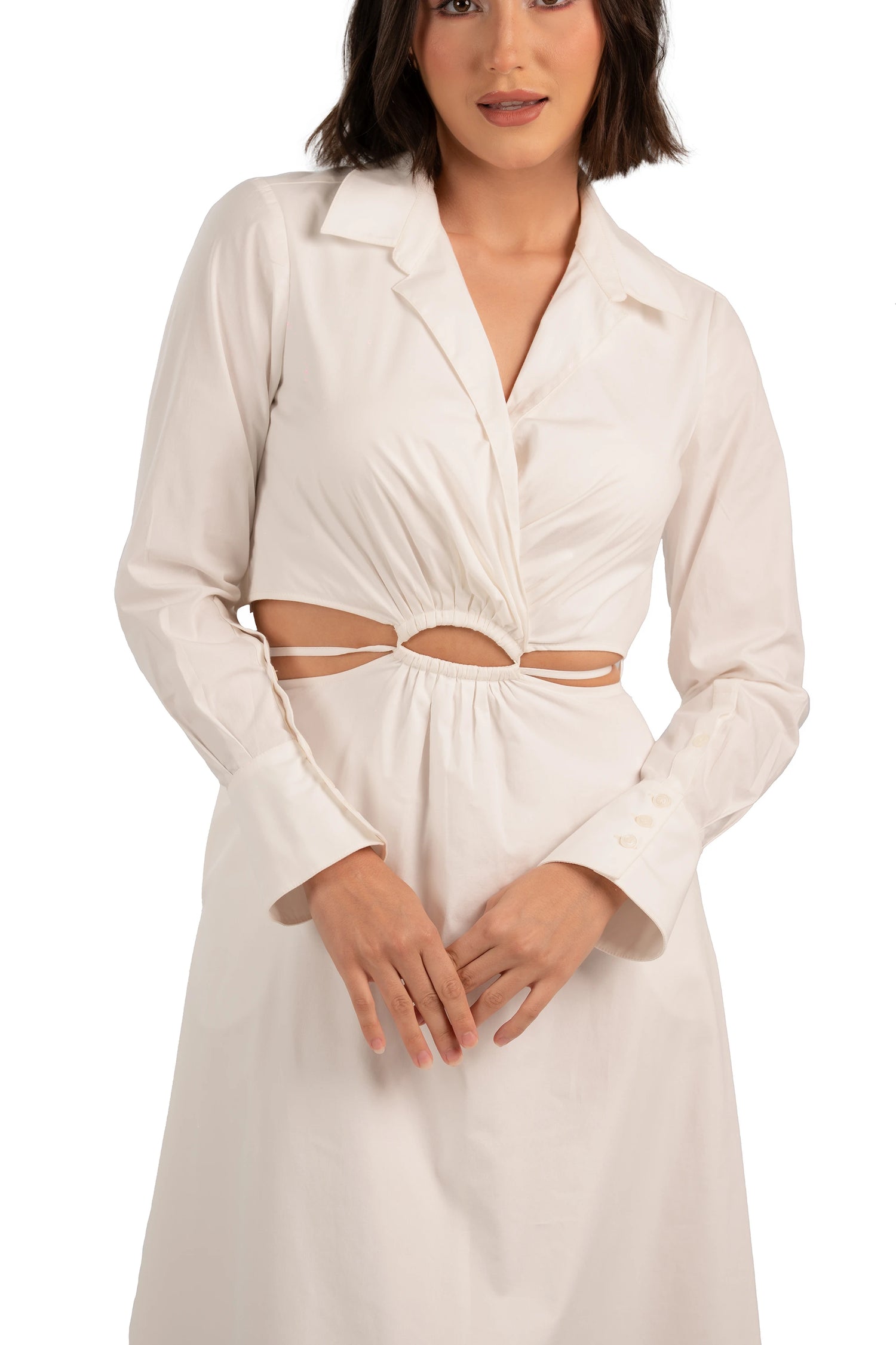 Detailed front close-up of cream maxi dress showing ruched bodice, waist cutout, and buttoned cuffs.