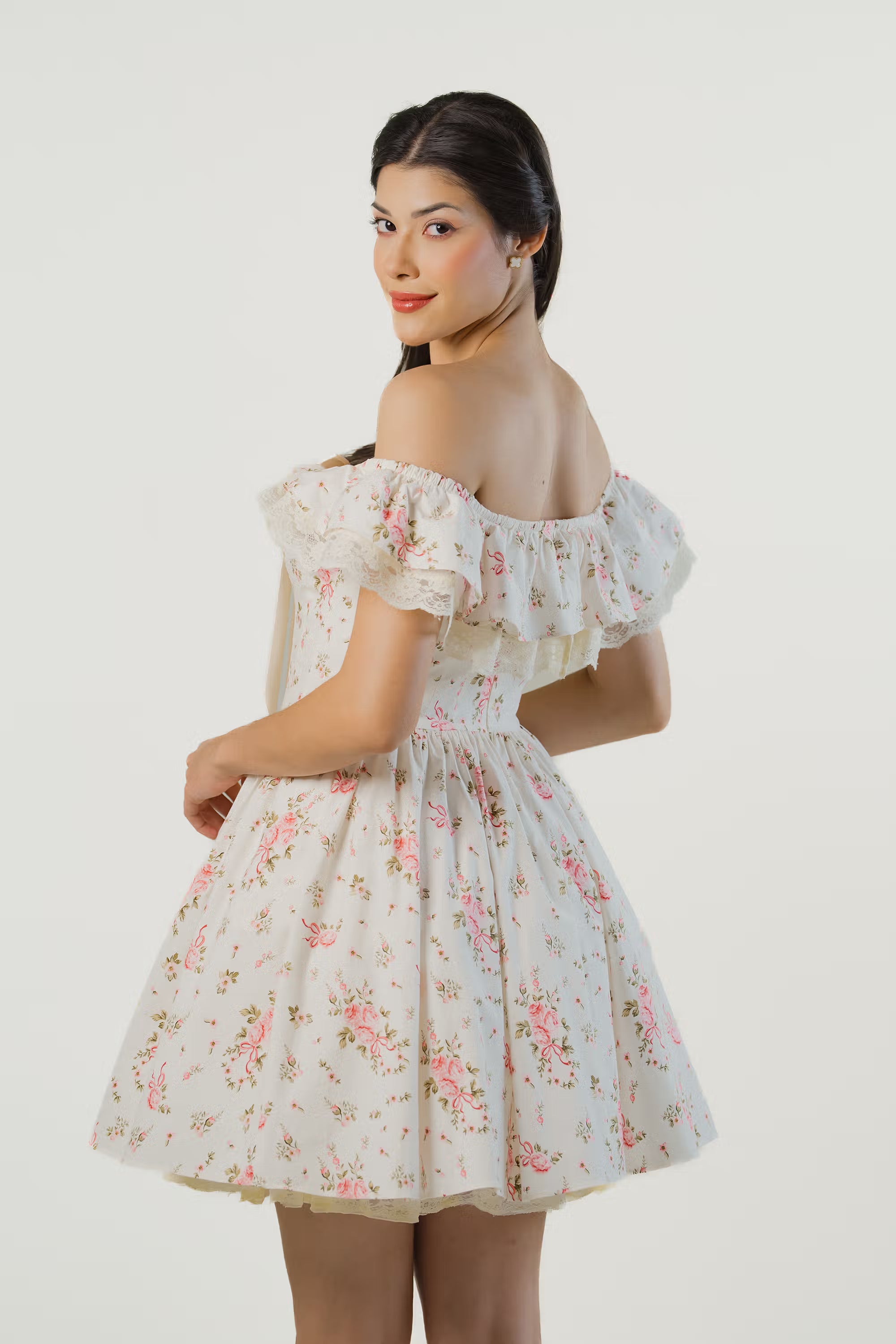 Back view of ivory floral off-shoulder dress with lace ruffle sleeves and fitted waist.
