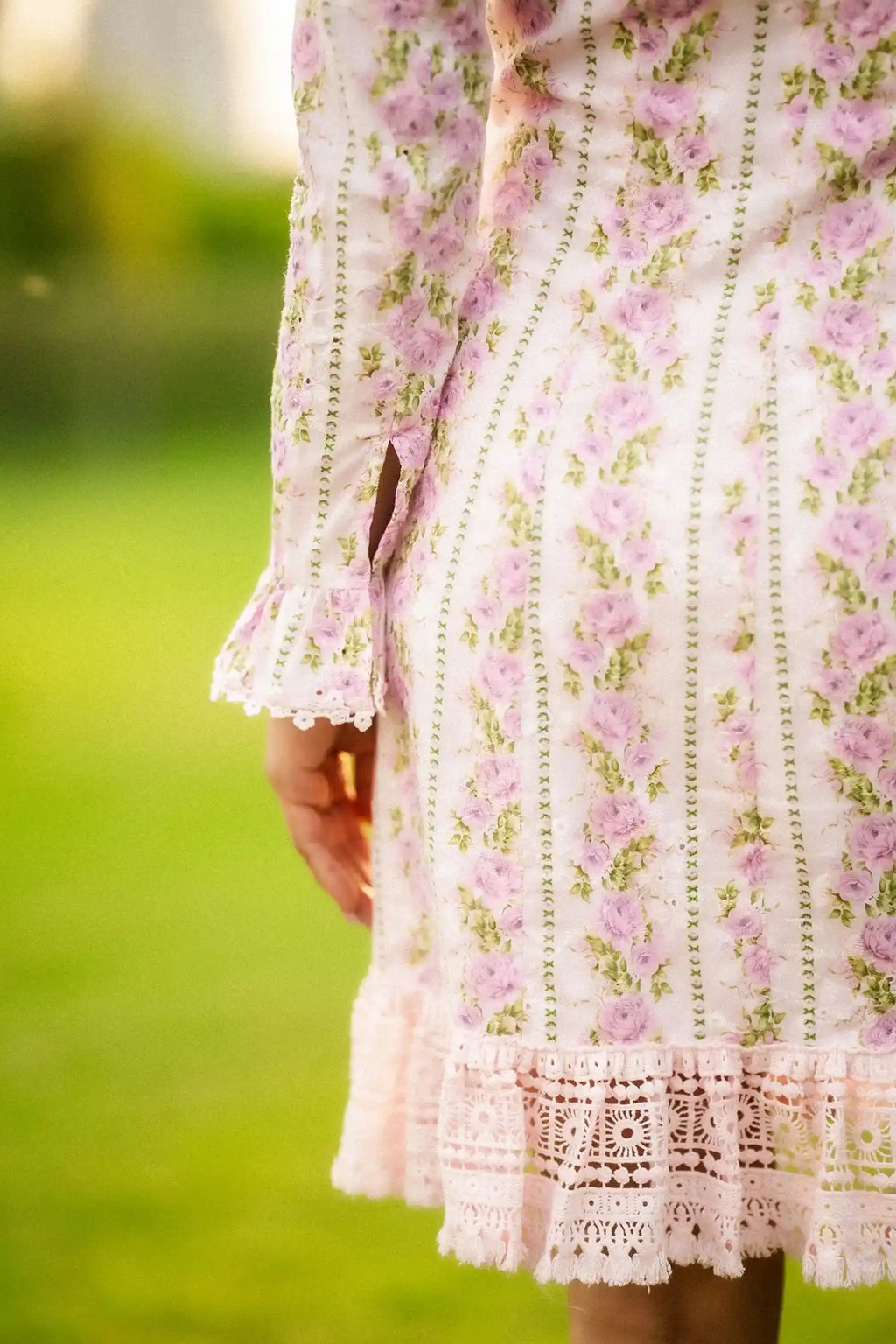 Back view of white floral mini dress with pink rose print