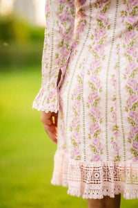 Back view of white floral mini dress with pink rose print