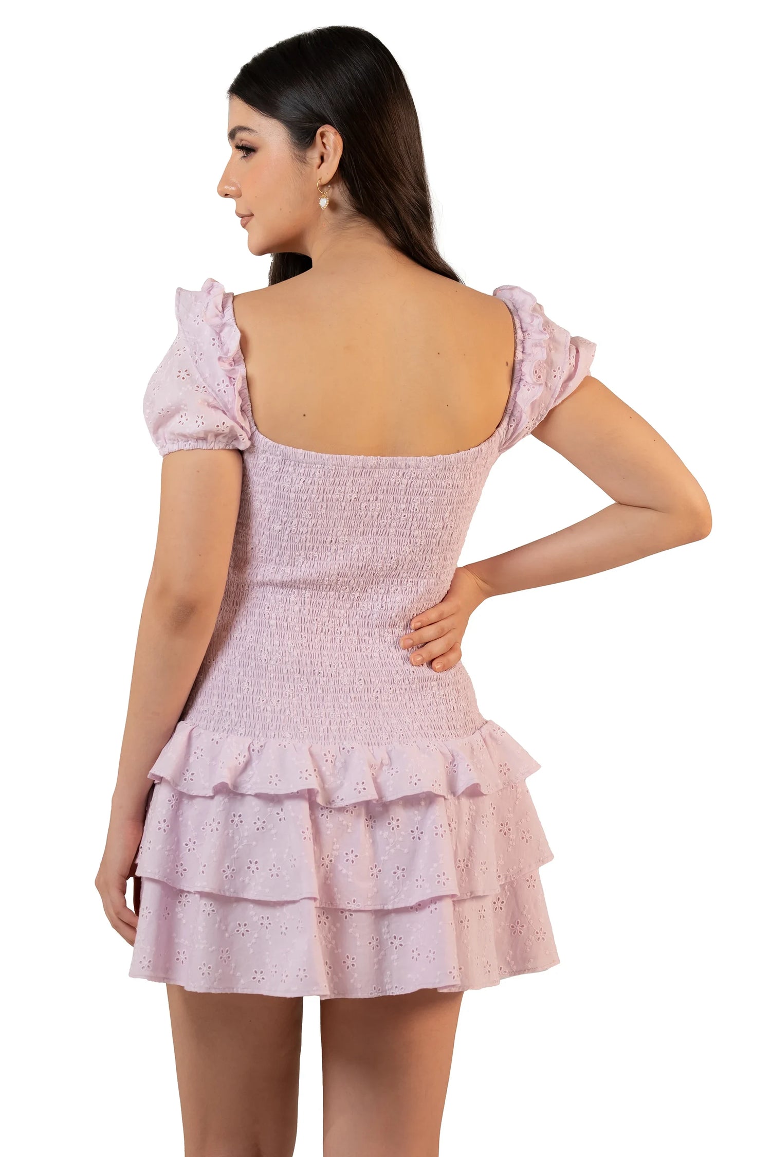 Back view of lavender eyelet mini dress with low square back, full smocking, and double tiered ruffle hem.