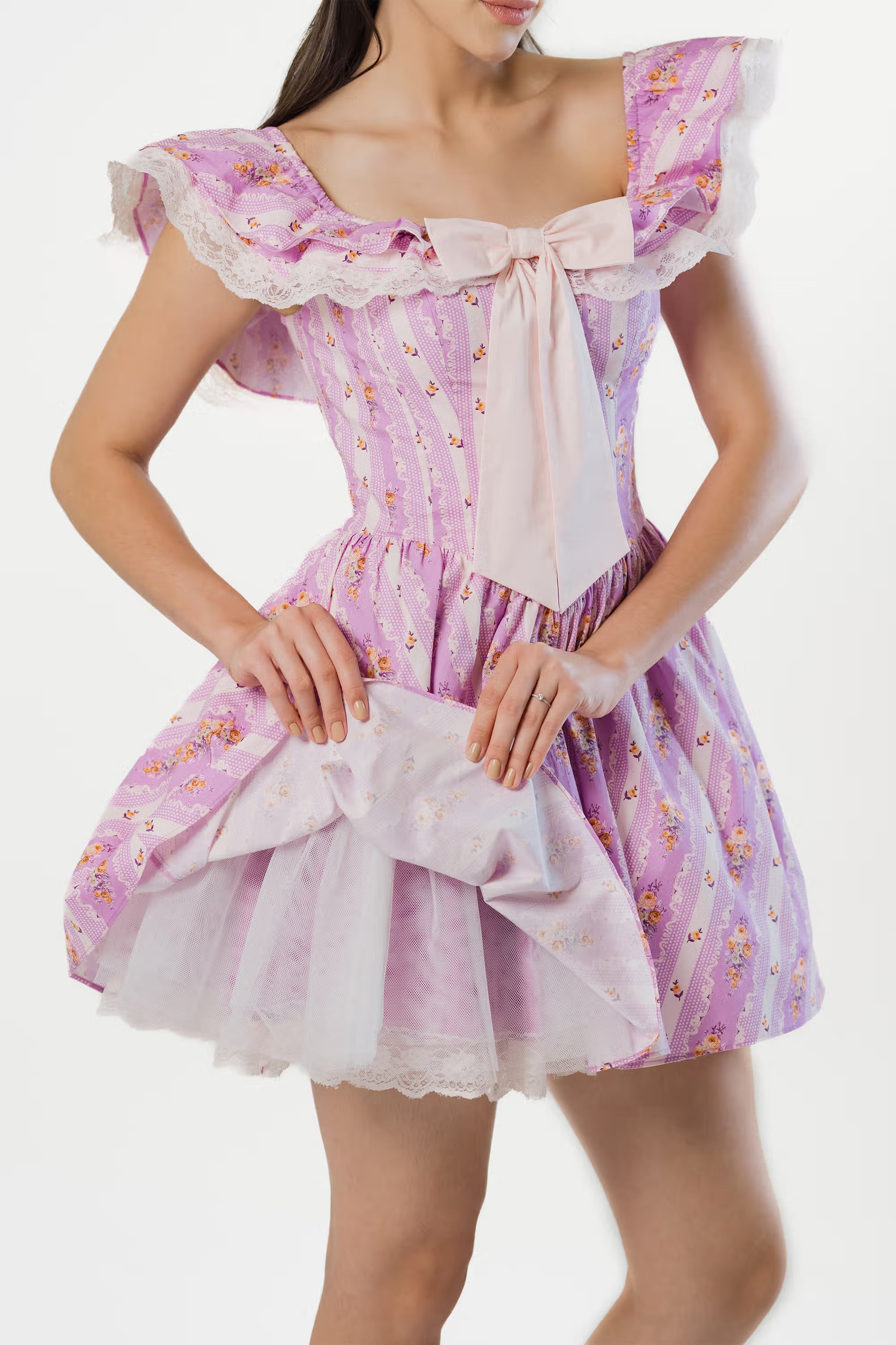 Close-up of lavender floral mini dress with wide bow and lace neckline detail.