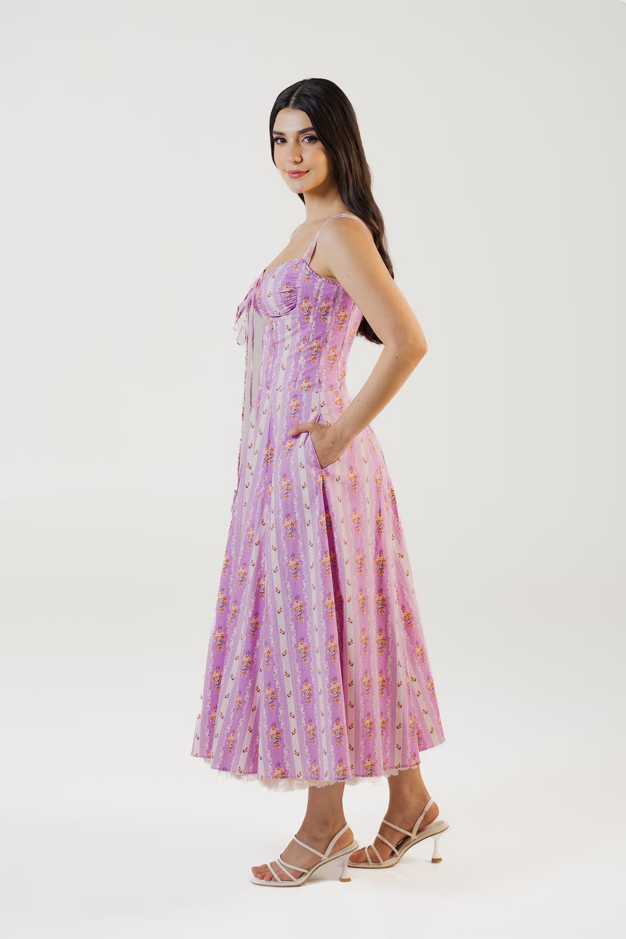 Side view of lavender floral corset midi dress with fitted waist and A-line skirt