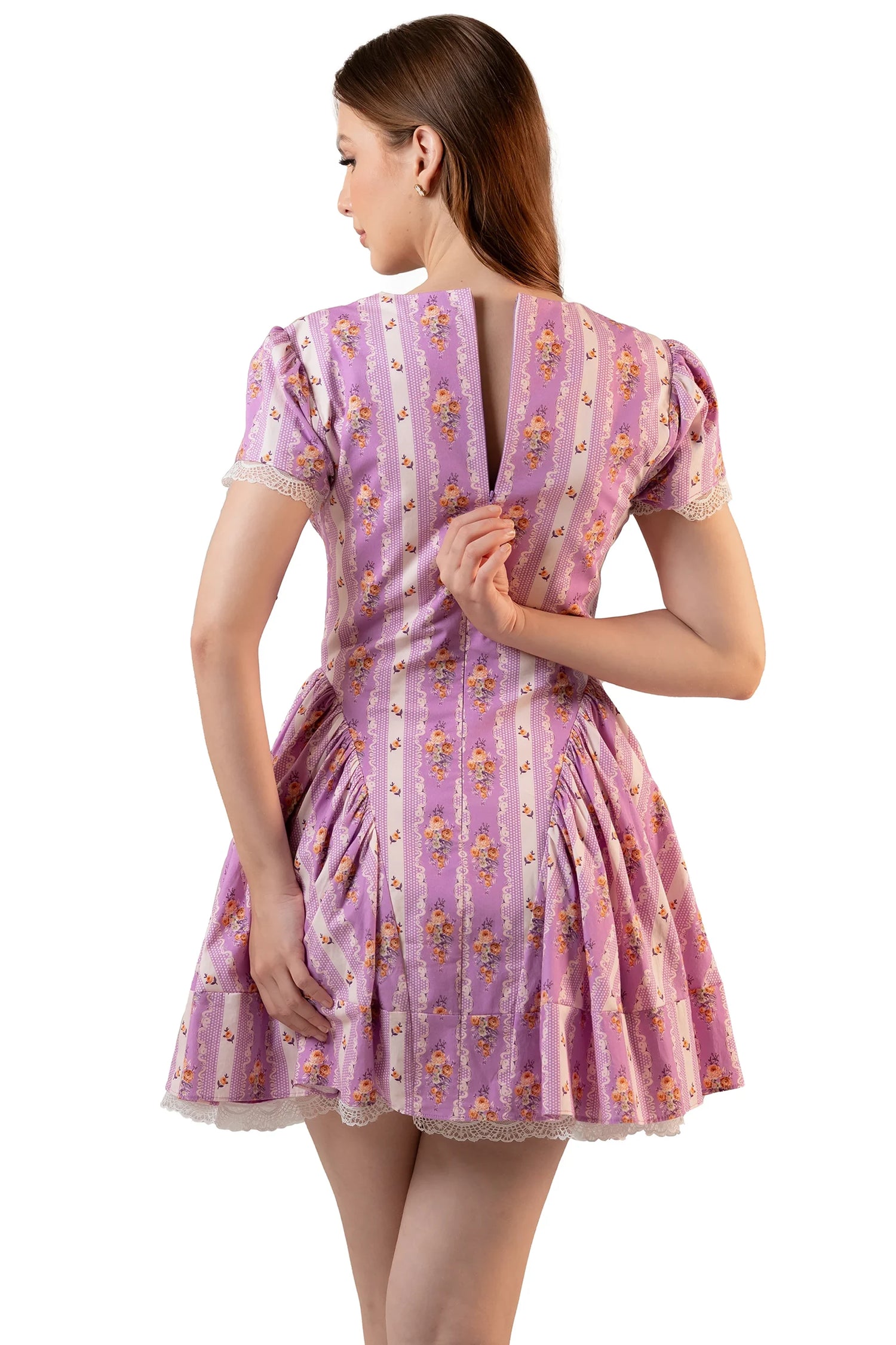 Back view of lavender floral mini dress with center-back zipper opening, puff sleeves and scalloped lace hem