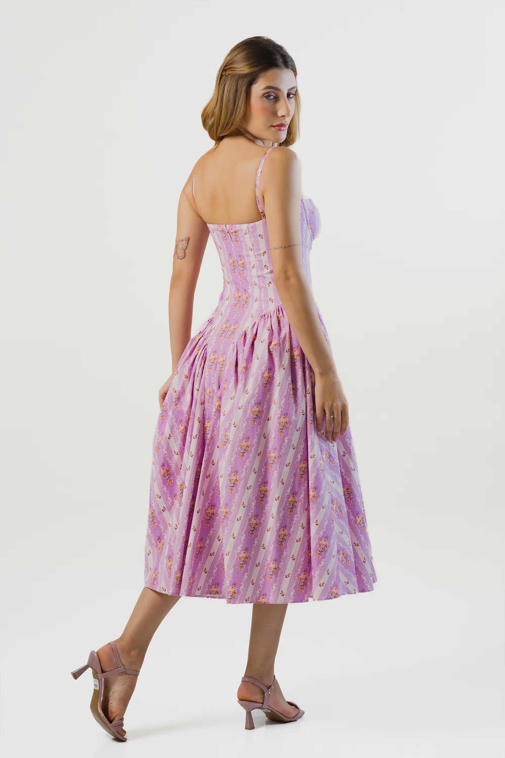 Back view of lavender floral striped corset midi dress with flowy skirt