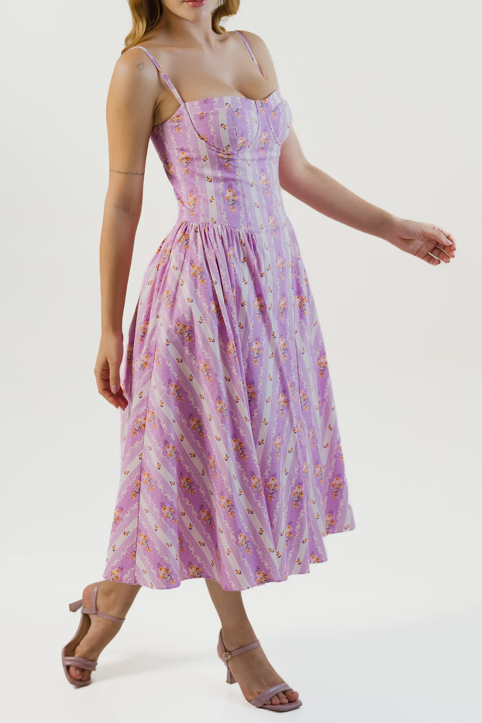 Women walking in lavender floral striped corset midi dress and strappy heels