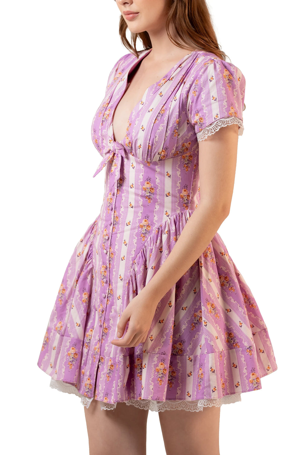 Side three-quarter view: lavender floral tie-front mini frock with puff sleeves and gathered fit-and-flare skirt