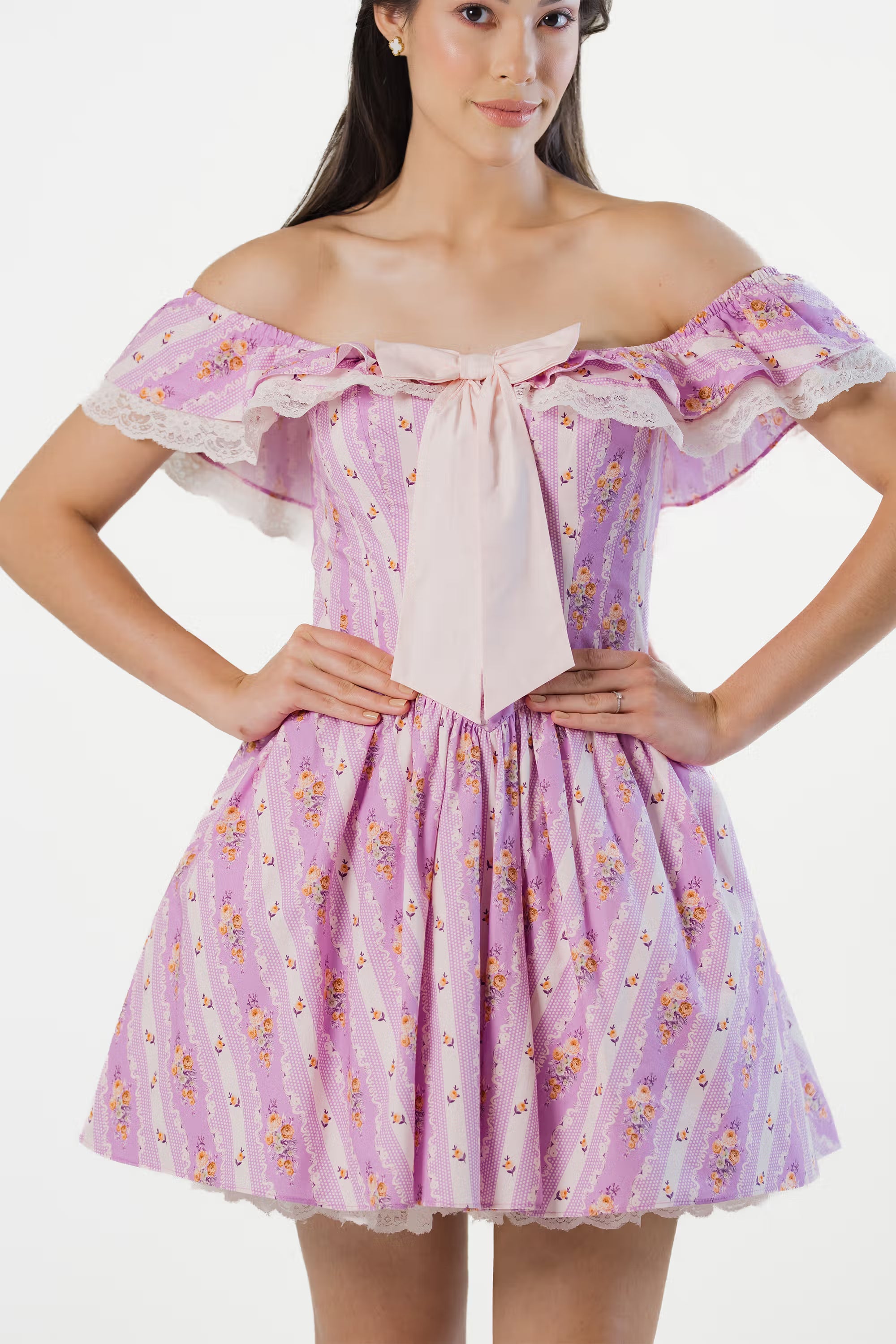 Close-up of lavender off-shoulder dress with pink bow and lace trim