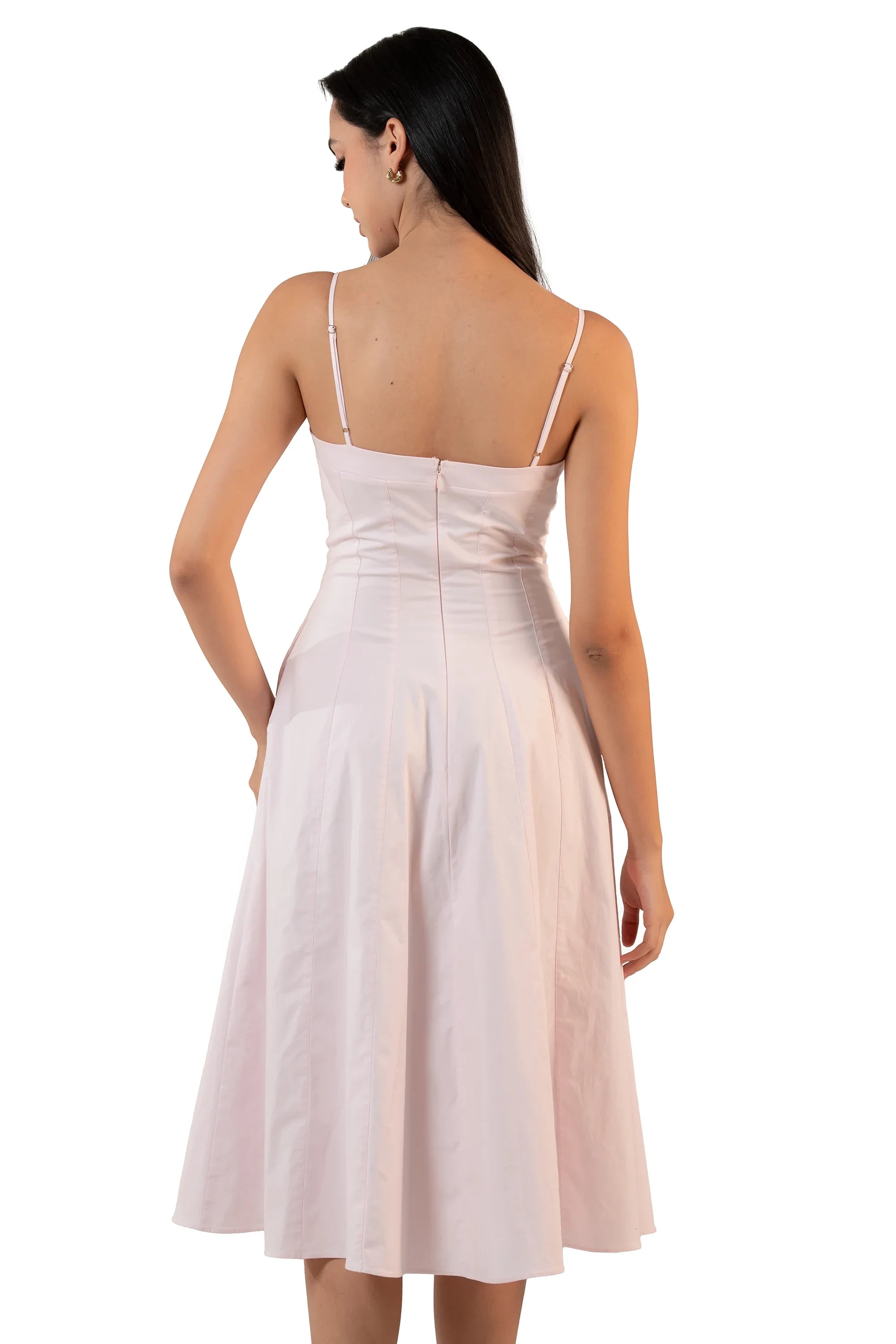 Back view of a light pink spaghetti strap midi dress featuring zip closure and flared A-line skirt – elegant feminine look.