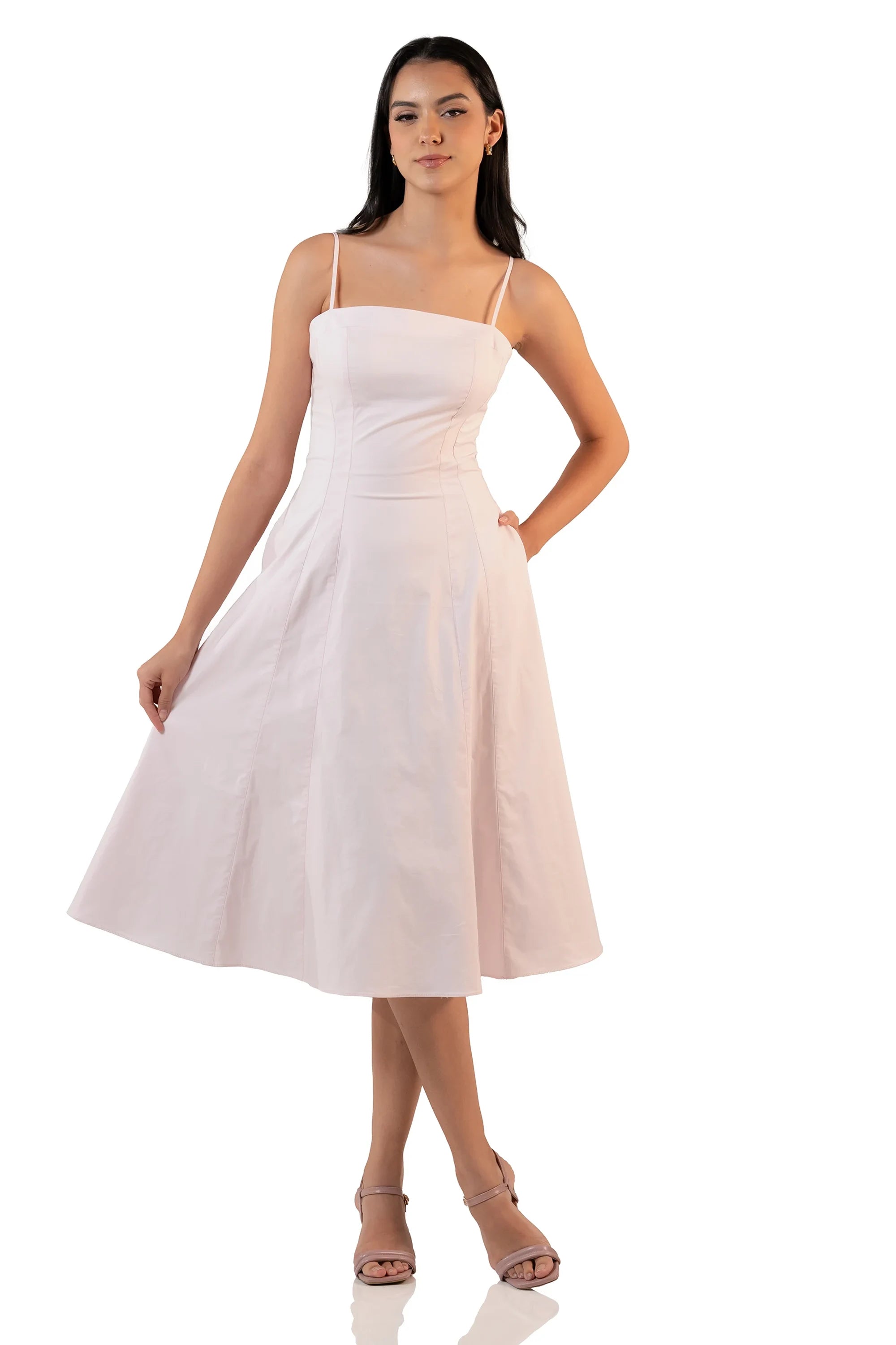 Front view of a model in a light pink sleeveless midi dress with square neckline, fitted bodice, and flared skirt – classy outfit.