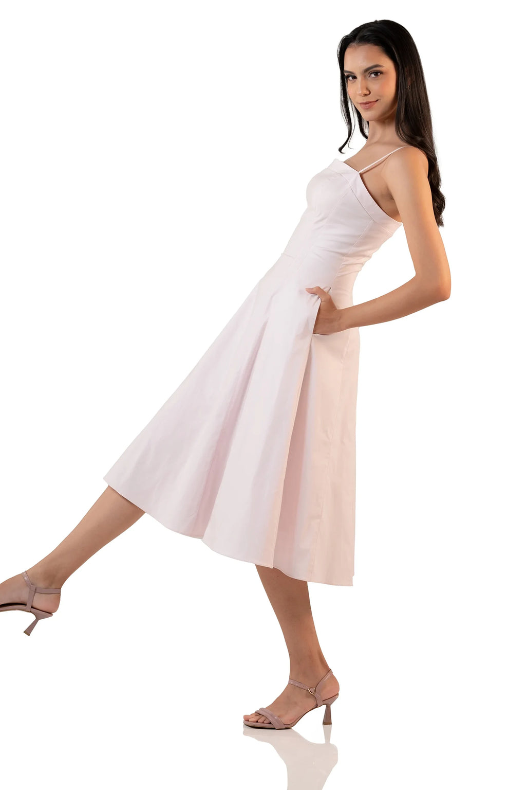 Light pink spaghetti strap midi dress side view showing flowy A-line skirt and fitted waist – chic feminine fashion.