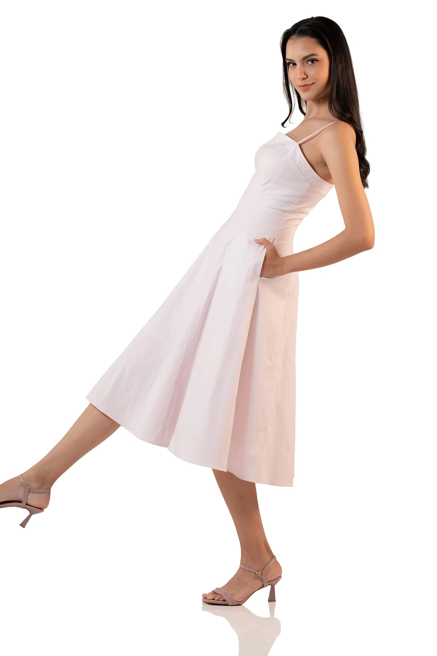 Light pink spaghetti strap midi dress side view showing flowy A-line skirt and fitted waist – chic feminine fashion.