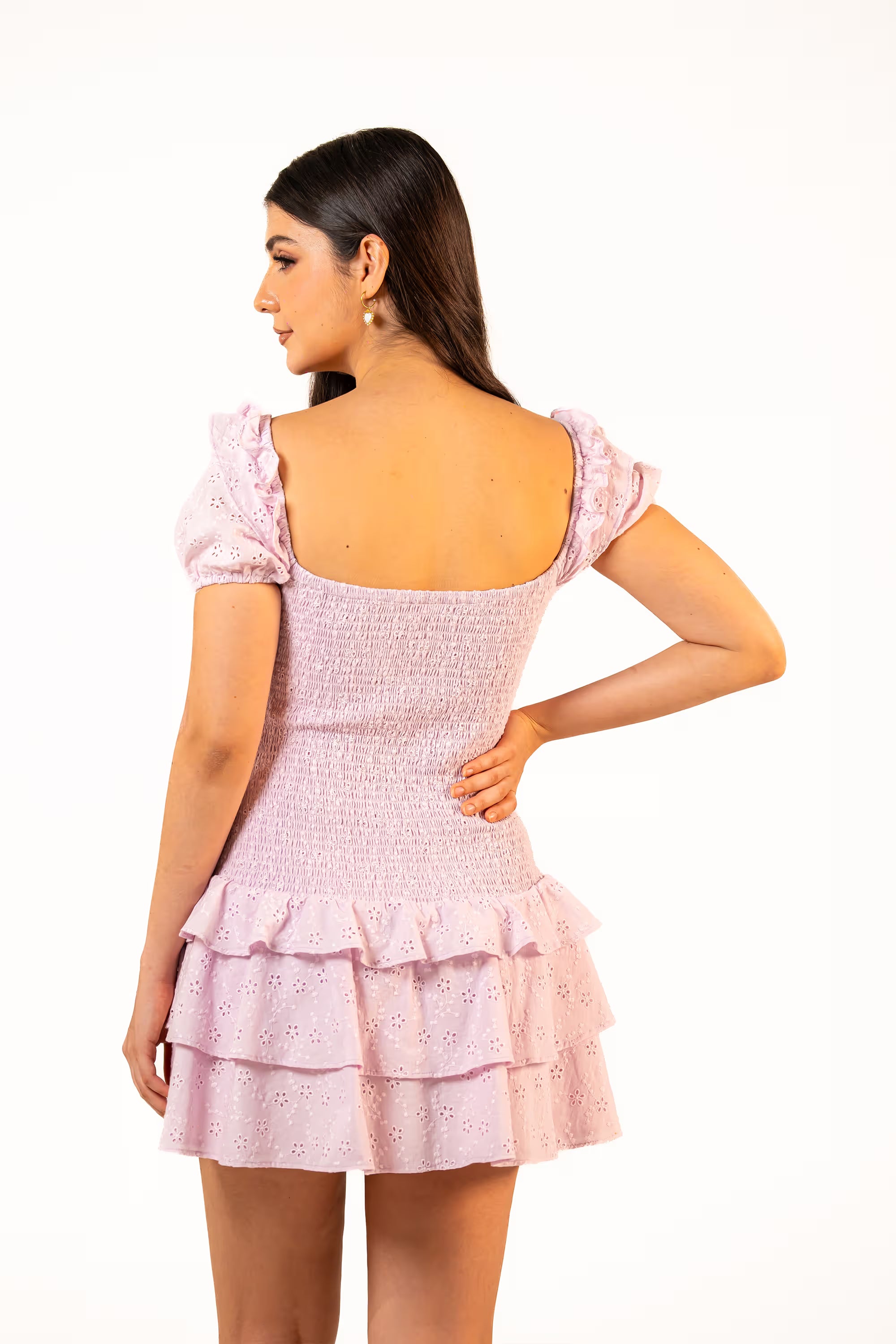 Back view of lilac ruffle eyelet mini dress with smocked fit and layered skirt, casual outfit