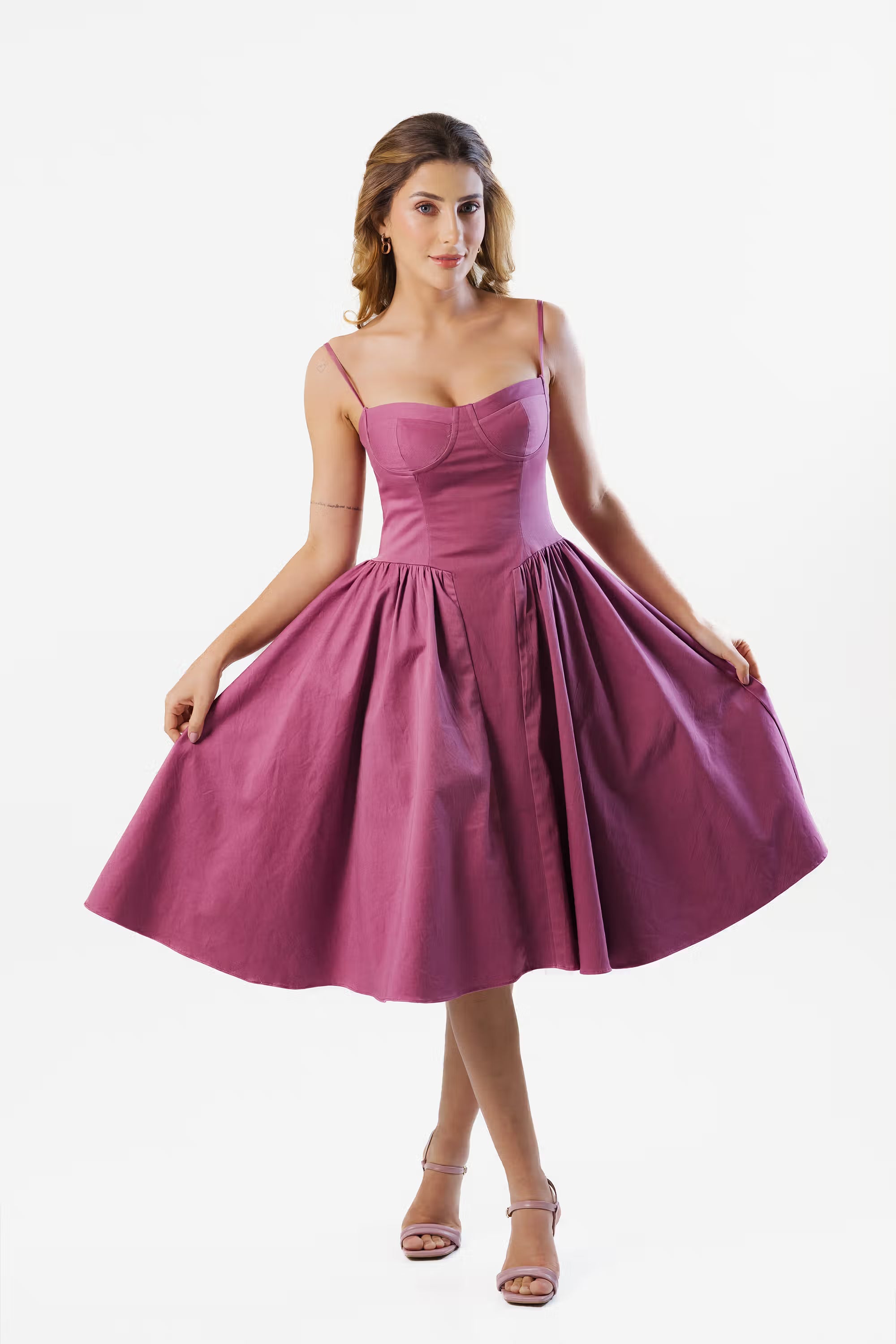 Elegant magenta midi-length dress for women, sleeveless design with a flattering fit and flare cut.