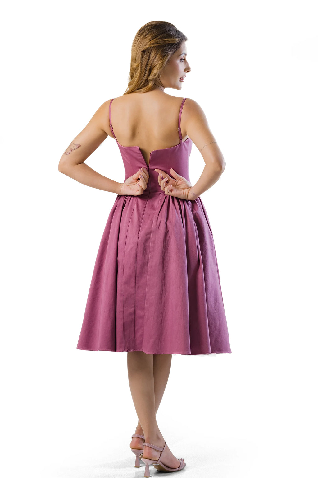 Back view showing center-back zipper on mauve cotton midi dress with adjustable straps and flared skirt