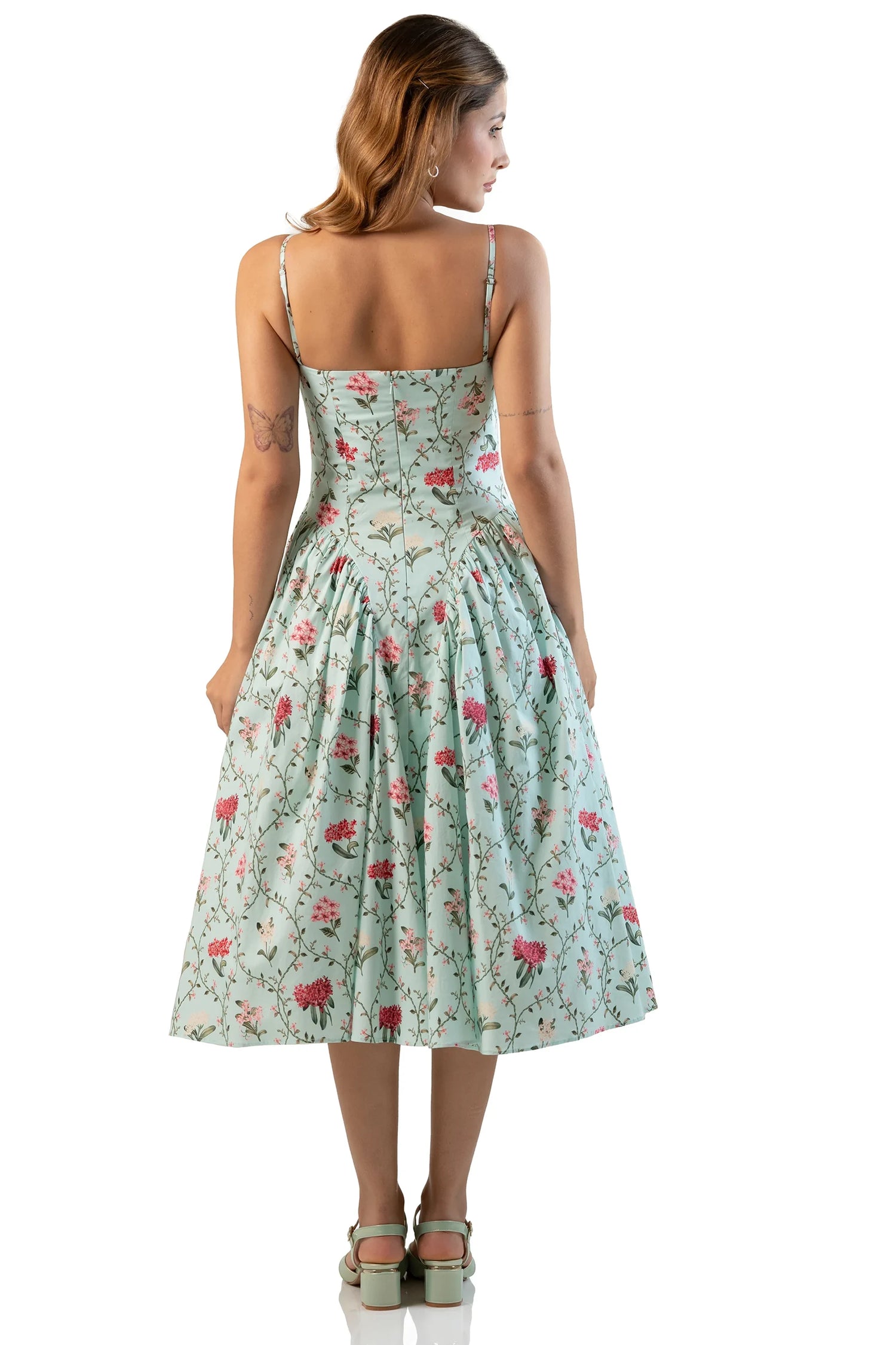 Back view of mint floral strappy midi dress on model