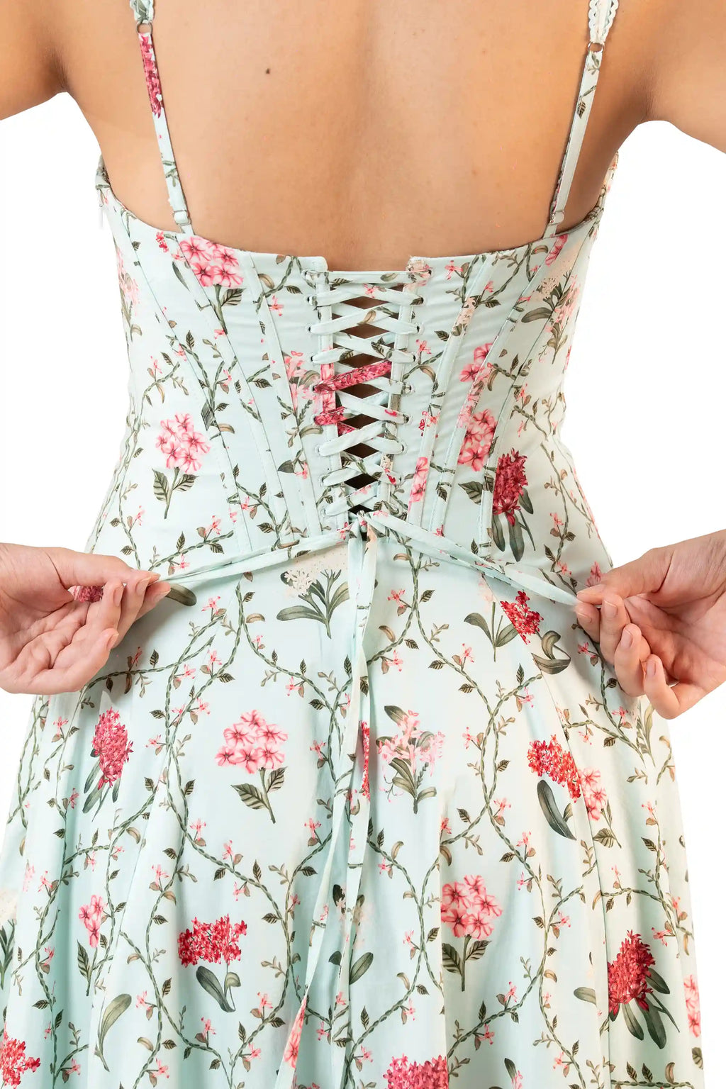 Close-up of corset lace-up back on mint green floral midi dress with adjustable straps