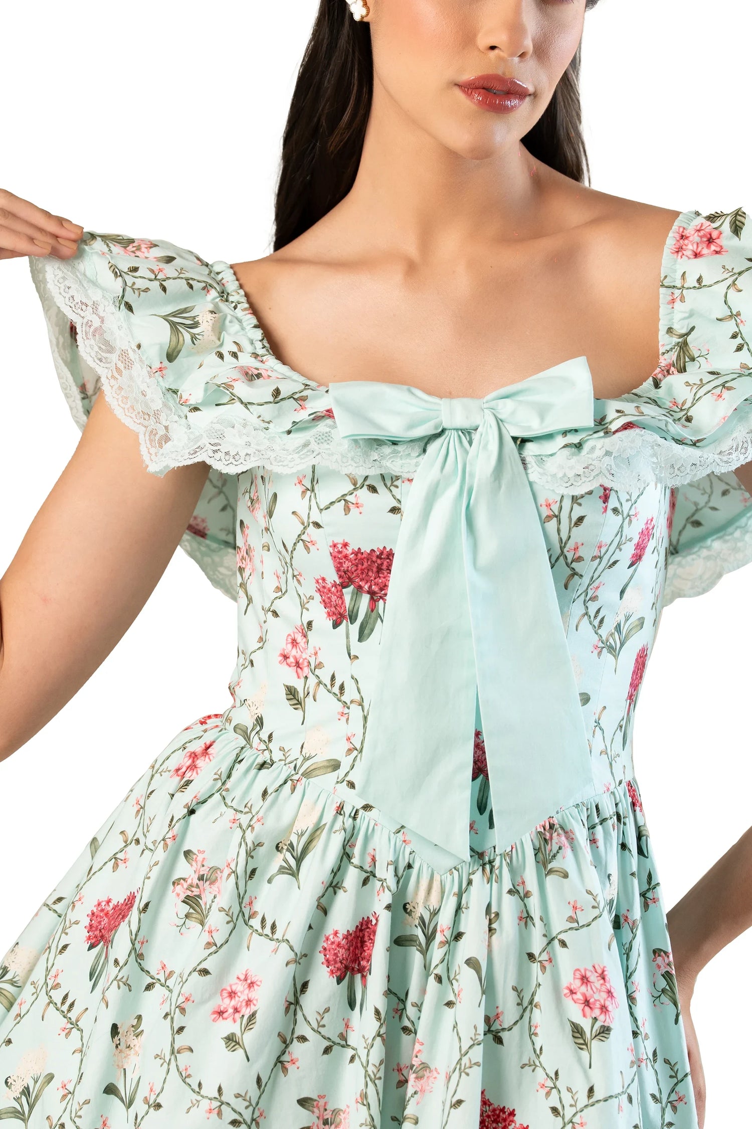 Close-up: mint floral off-shoulder mini with oversized bow and lace ruffle