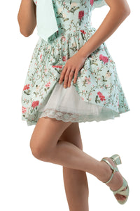 Close-up of tulle underskirt with lace hem under mint floral mini dress