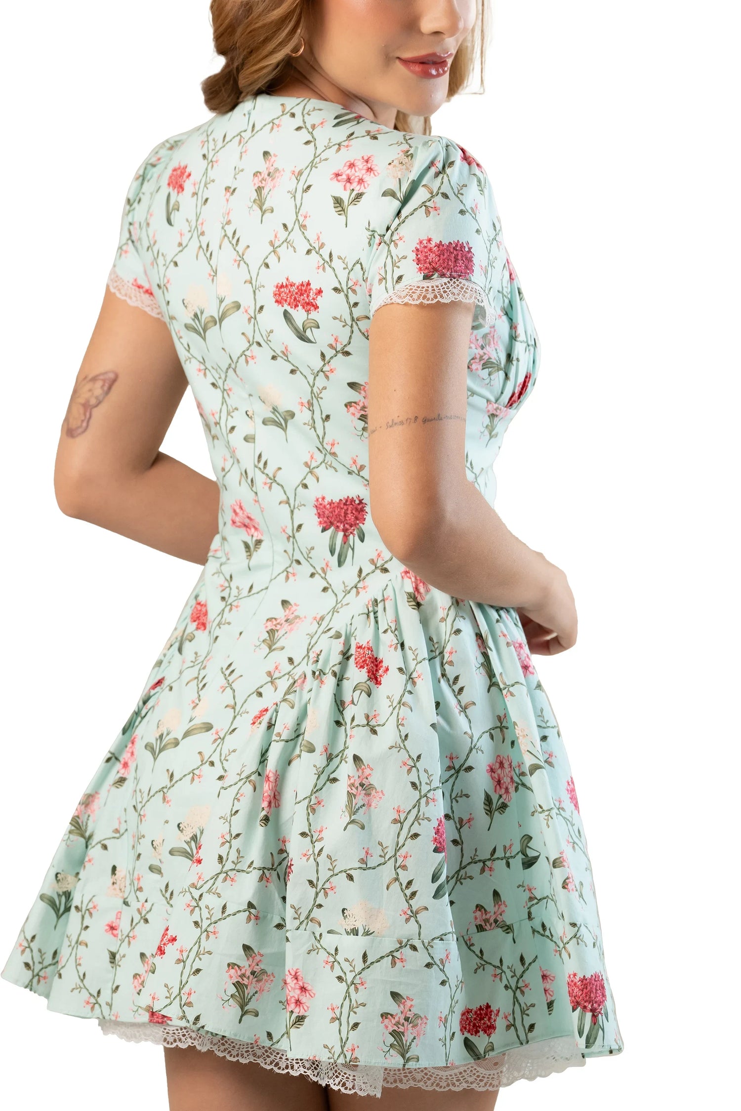 Back view of mint floral short-sleeve mini dress; lace-trim hem, gathered skirt