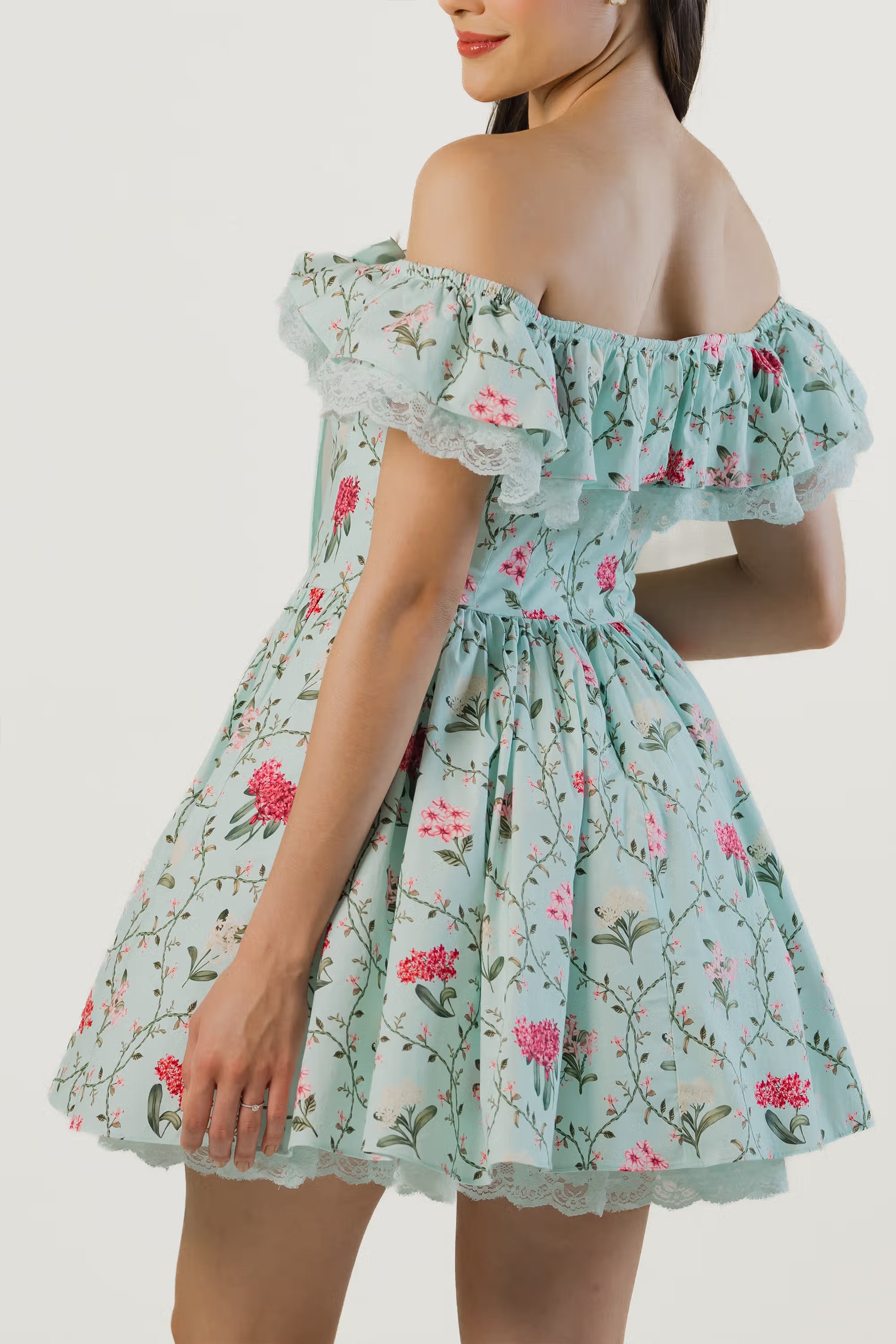 Back and side view of mint green floral off-shoulder short dress with lace and fitted waist.