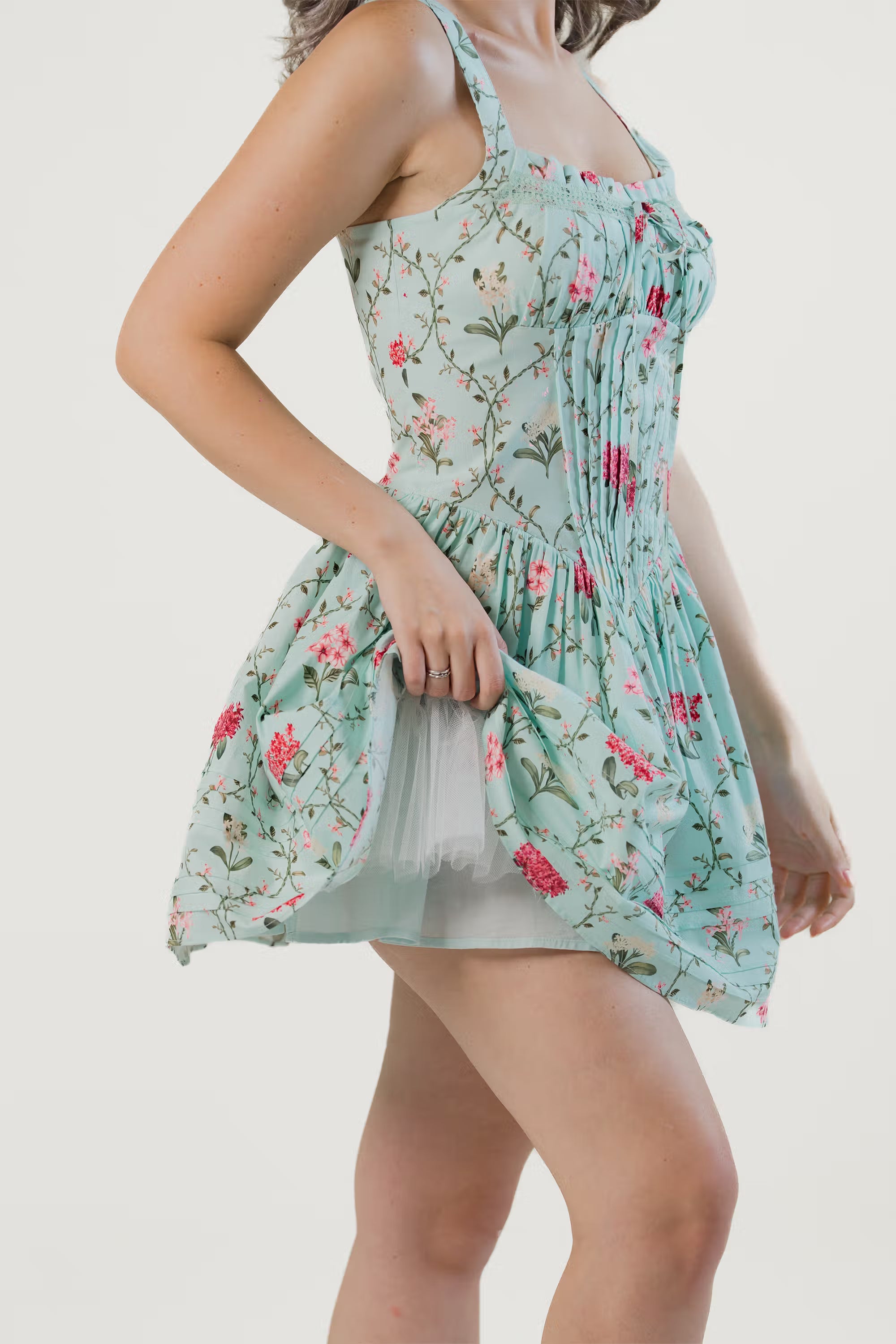 Bodice closeup of mint green mini dress with delicate floral patterns