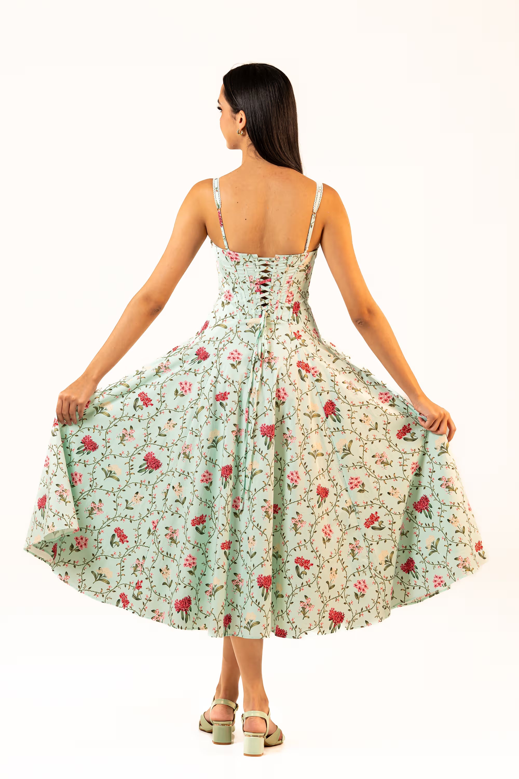 Back view of mint green floral corset midi dress with lace-up tie closure and flared silhouette